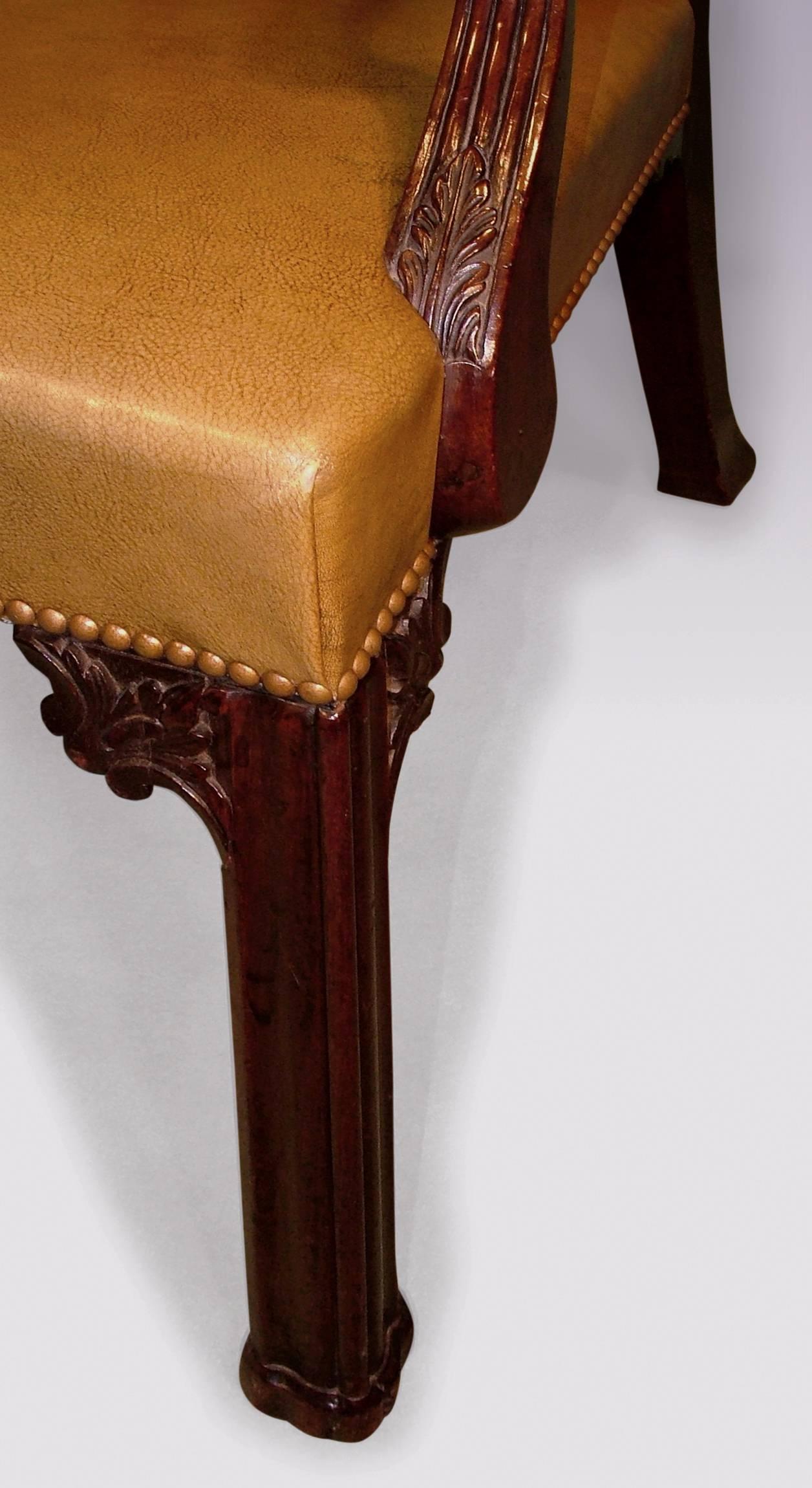 A mid-18th century Chippendale period mahogany armchair, having acanthus carved and scrolled top rail, above Gothic arch pierced back splat, and outs wept carved, receded arms. The chair with stuff over leather seat supported on moulded legs with