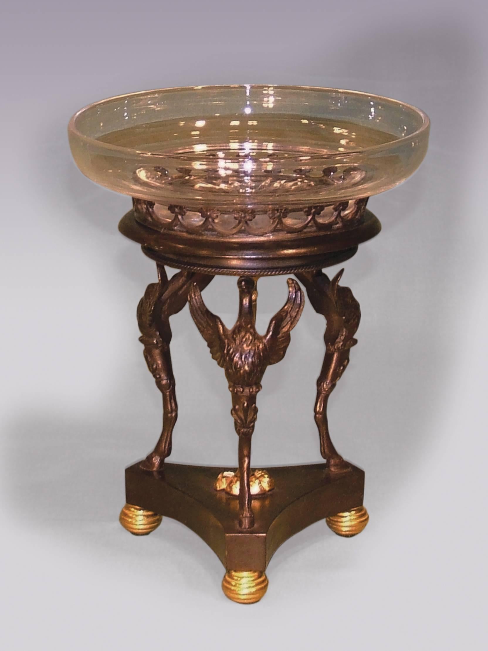 An early 19th century Regency period bronze and ormolu single Tazza having a galleried top, raised on triple swan and hoof monopodia with central engine turned tapering column, supported on triform platform base ending on reeded ball feet. (Fitted