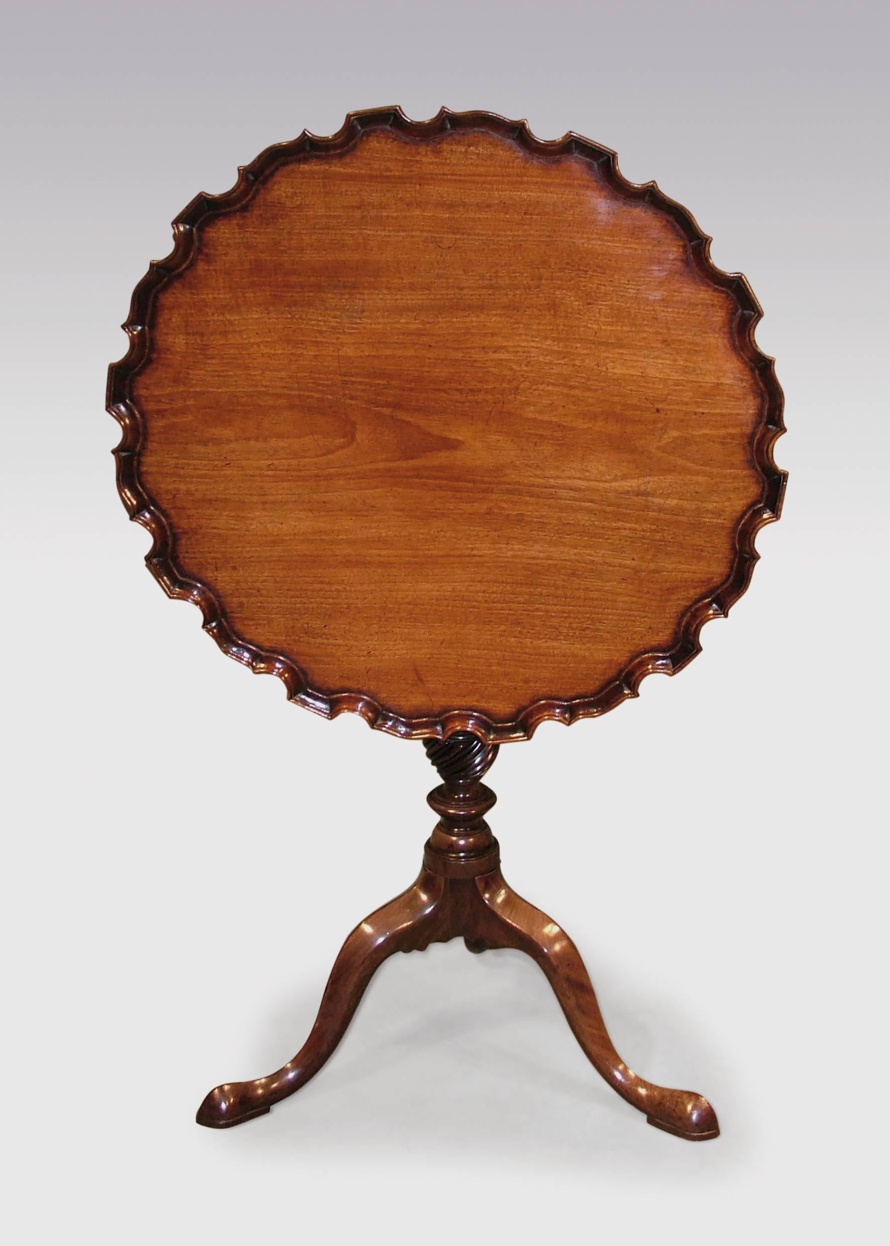 A mid-18th century Chippendale period figured mahogany tripod table, having well caved piecrust edge top, supported on gun-barrel stem with spiral twist urn, ending on shaped three-splay legs and pad feet.