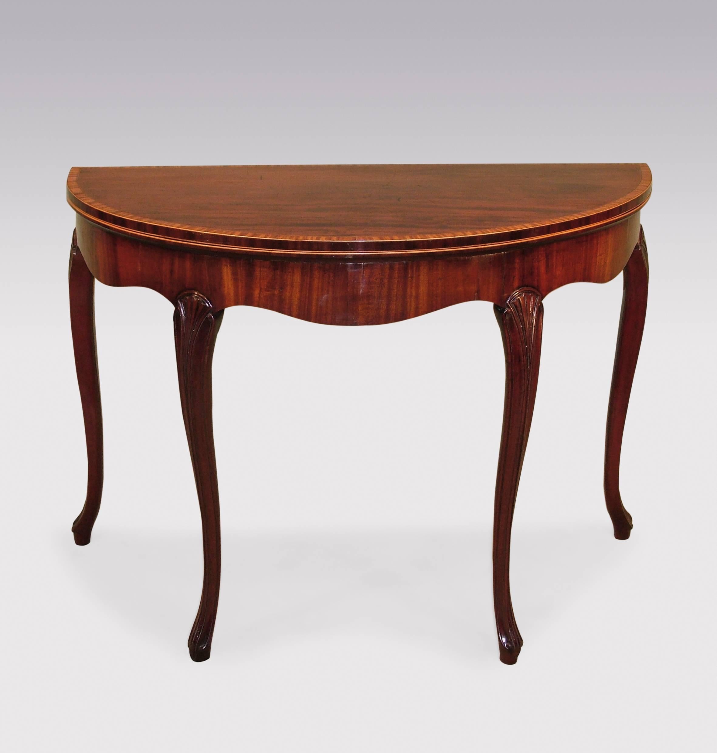 A fine pair of late 18th century George III period ‘transitional’ figured mahogany card tables, having boxwood and ebony strung, satinwood crossbanded half round tops, above serpentine shaped friezes, supported on carved and fluted cabriole legs,