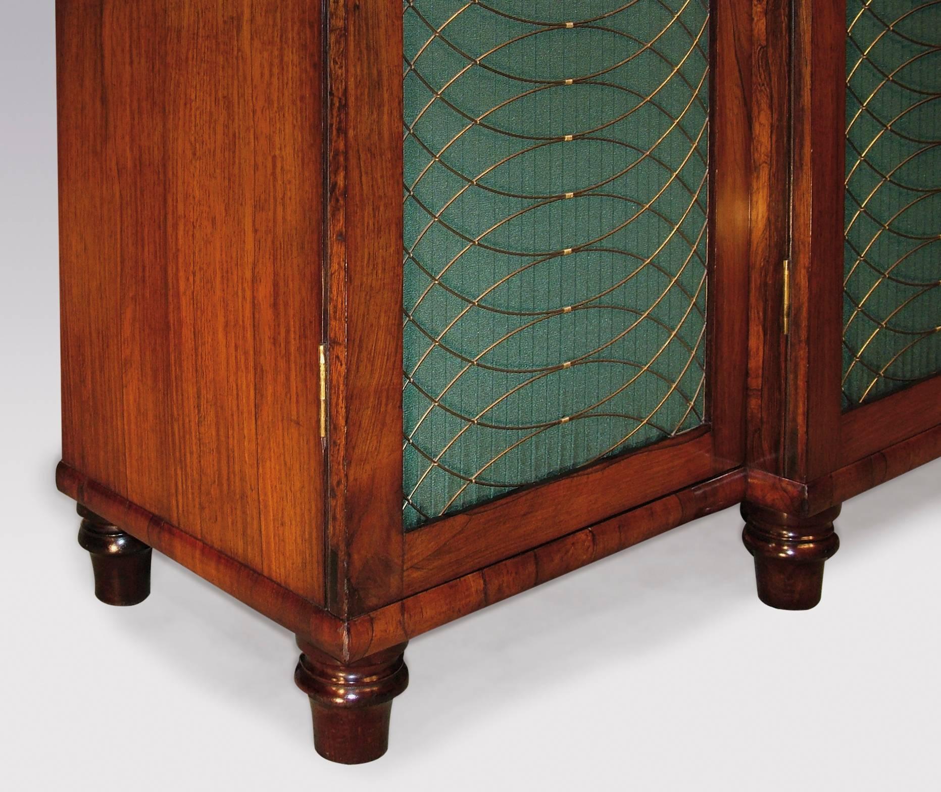 An early 19th century Regency period rosewood breakfront Chiffonier, having end-grain moulded edged top, above four silk-pleated brass grille doors, ending on turned feet.