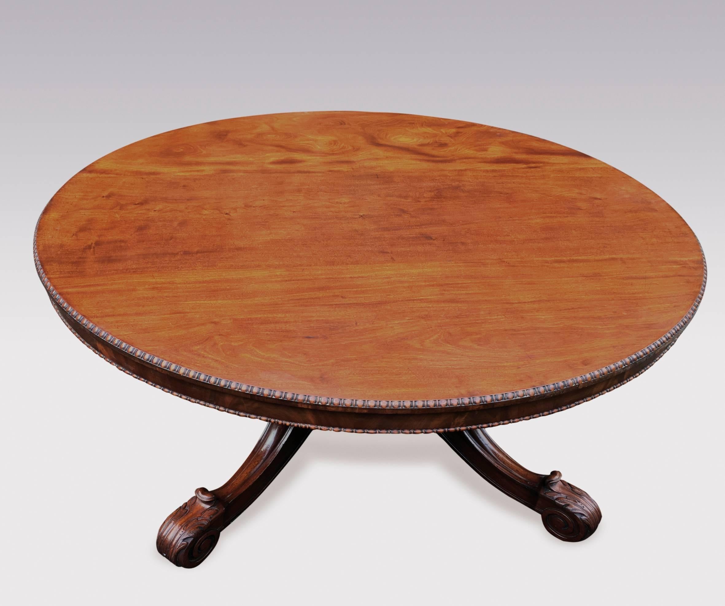 A fine quality William IV period well figured mahogany circular dining table, having beaded edged top above narrow frieze with further beaded decoration, raised on bold turned stem, ending on four-splay legs with acanthus and scroll carved