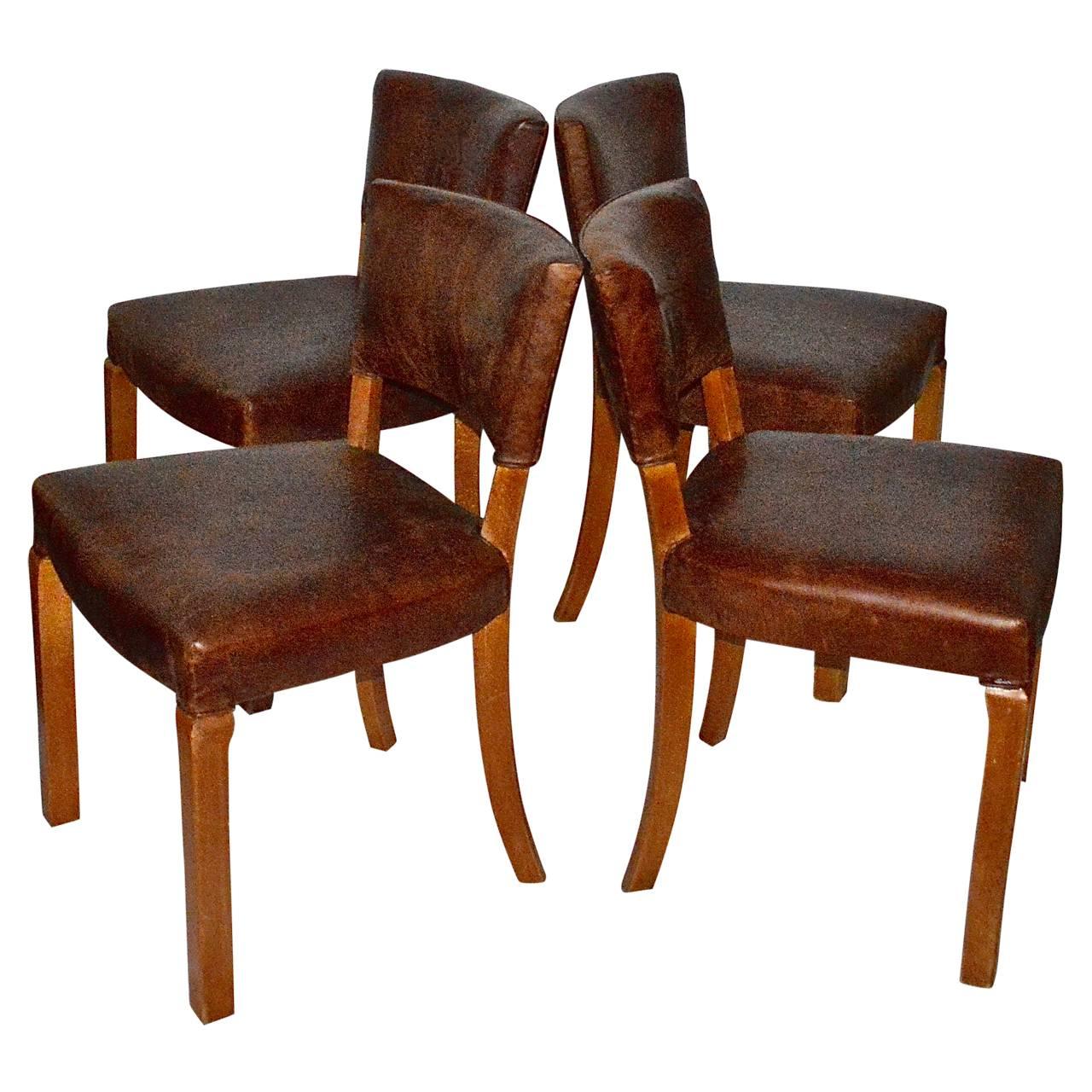 Four beautiful Art Deco dining chair, in a lovely patinated birchwood and newly upholstered in vintage leather.