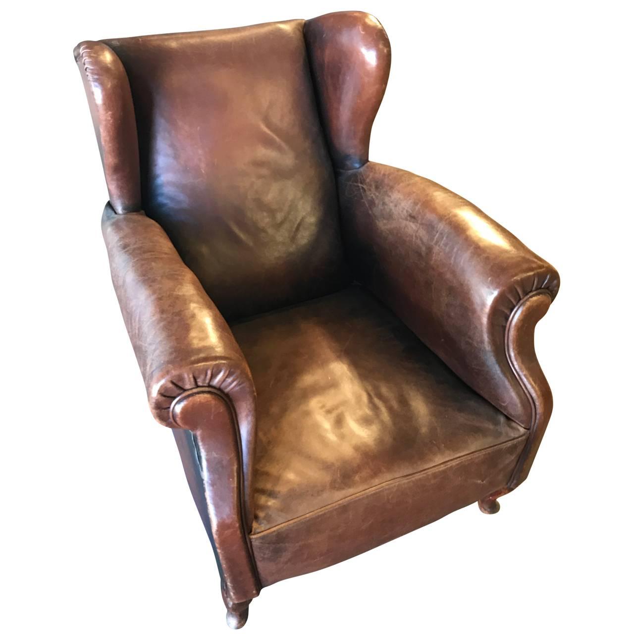 Beautiful low wingback armchair, in cognac colored leather with a great patina.

EUR125 delivery to most areas of London UK, Holland, Belgium, Northern Germany, Denmark and Sweden.