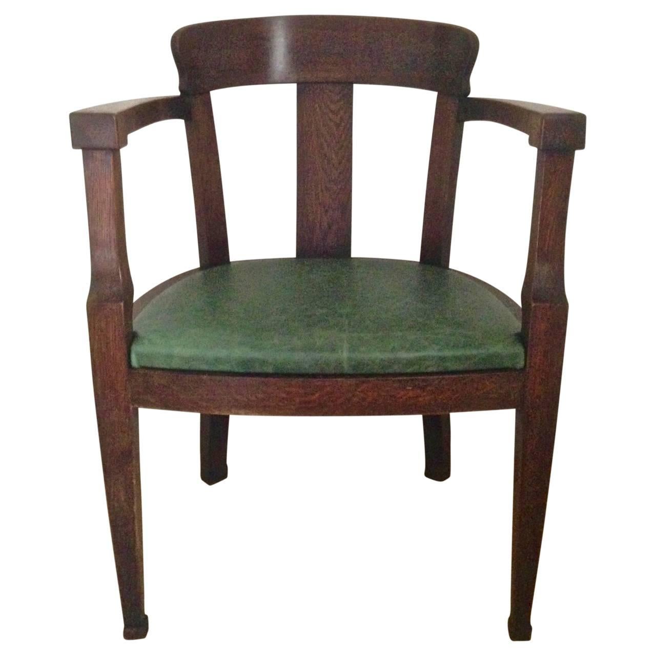 Beautiful dark solid oak Art Deco desk chair with newly upholstered green vintage leather.