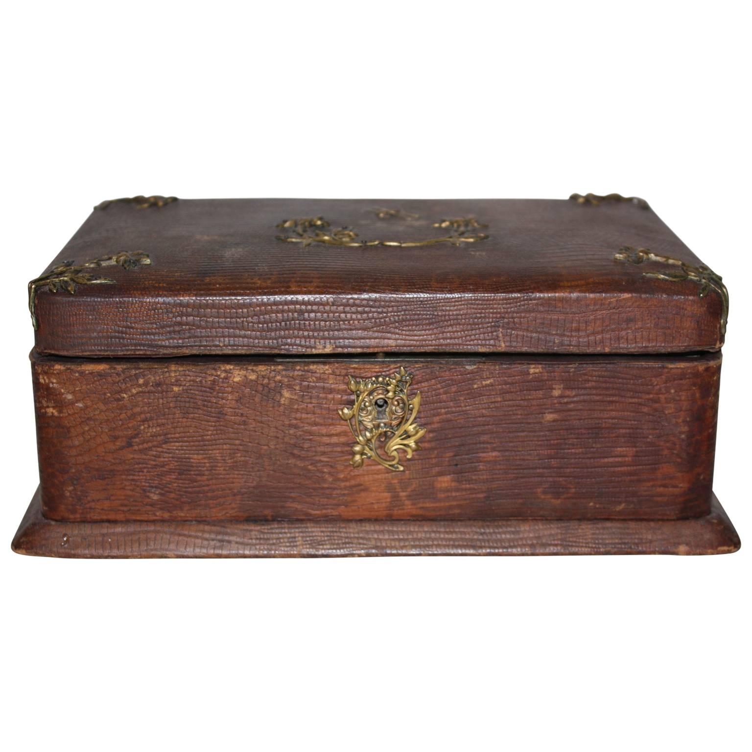 Beautiful early 20th century leather jewellery box with brass dragonflyes and flowers.