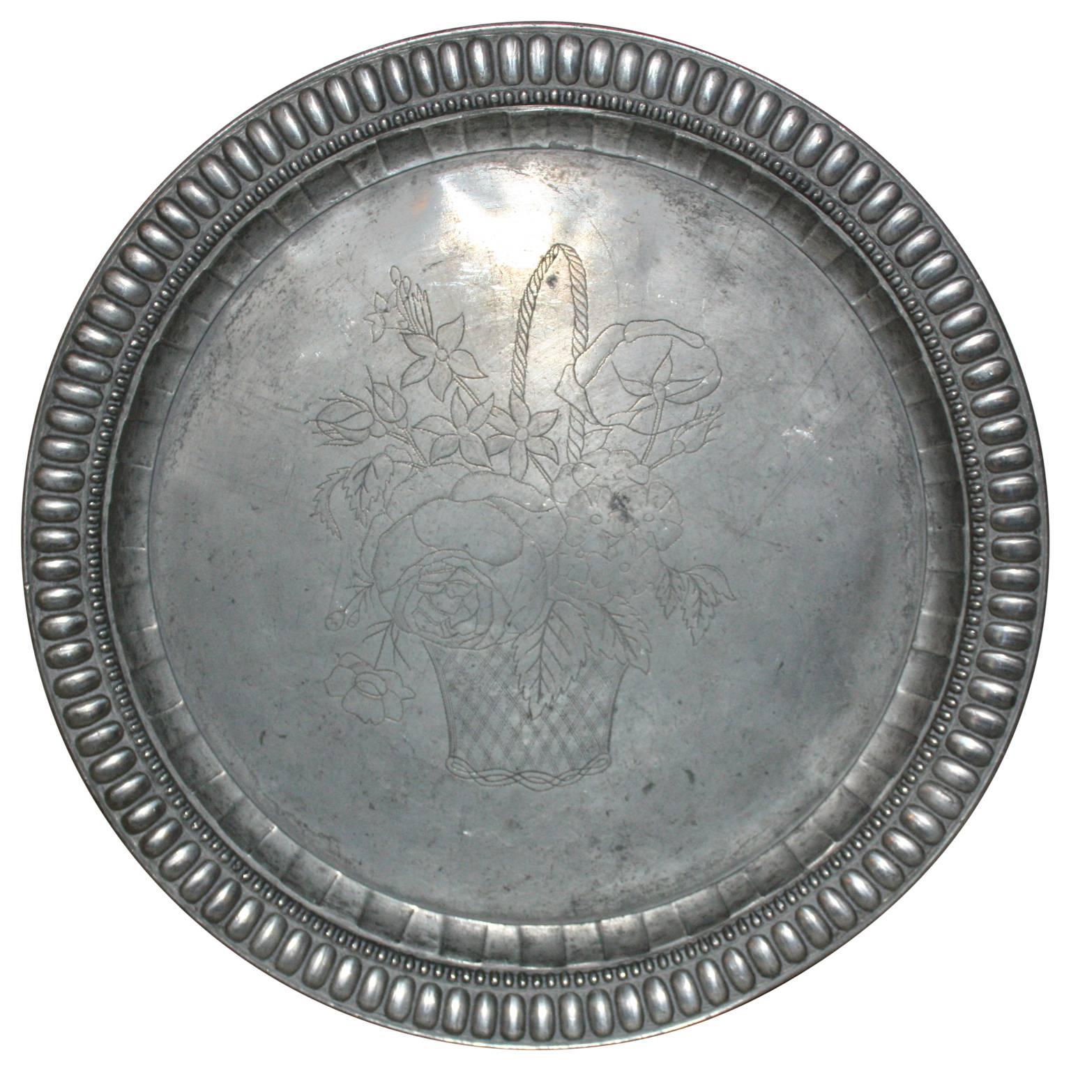Charming pewter dish with engraved floral motive in the middle and bevelled edge.