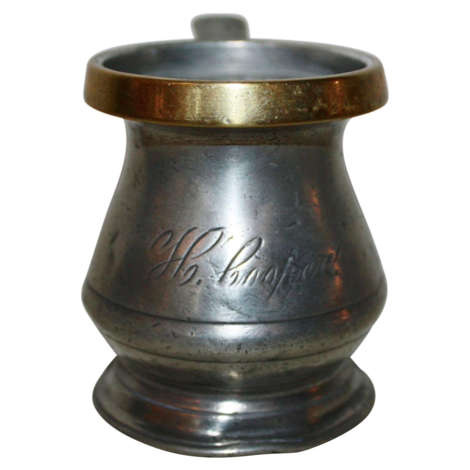 This is a Victorian liquid bellied lidless, Gill measurer with a brass rim and inscription of the owner.
A capacity mark such as ‘pint’ or ‘quart’ is self explanatory. Such marks became a legal requirement in 1836 in England. The presence of such a