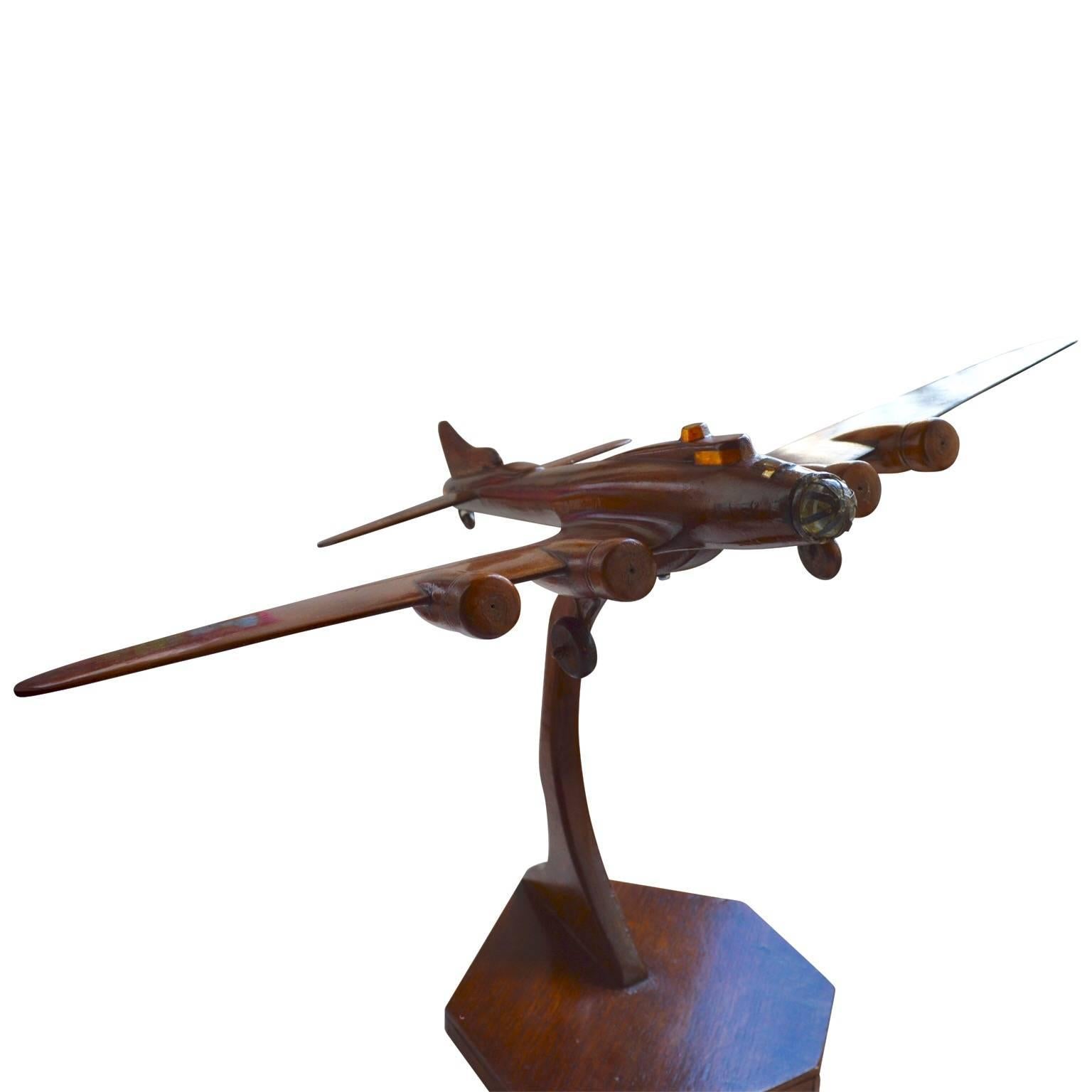 American model of Second World War B-17 bomber of lacquered wood and on a heptagon base of wood too. Correctly decorated with the American star on the left wing.
 