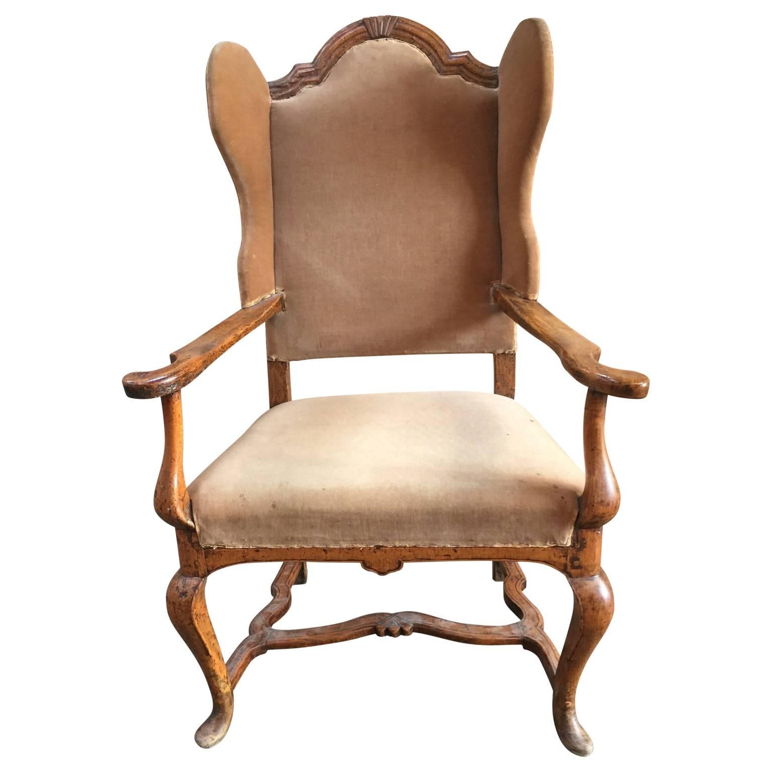 Large 18th century wingback armchair in oak, and with open-arm rests.