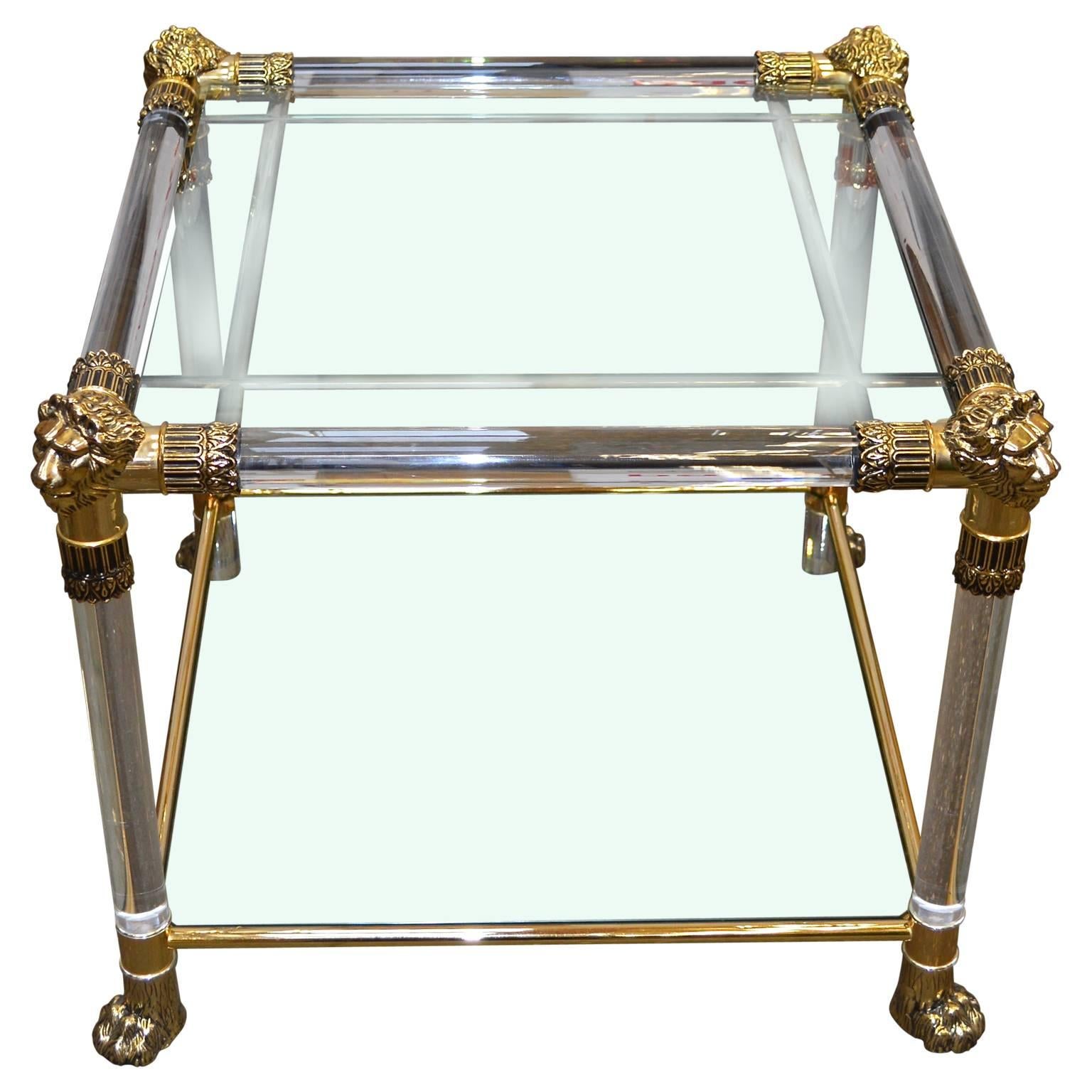Versace Lucite and glasstop side table with lion heads and feet of brass
The top glass piece has 4 circa 1 cm wide pound sign-shaped engraved lines. Lower glass piece for magazines has no decorations.