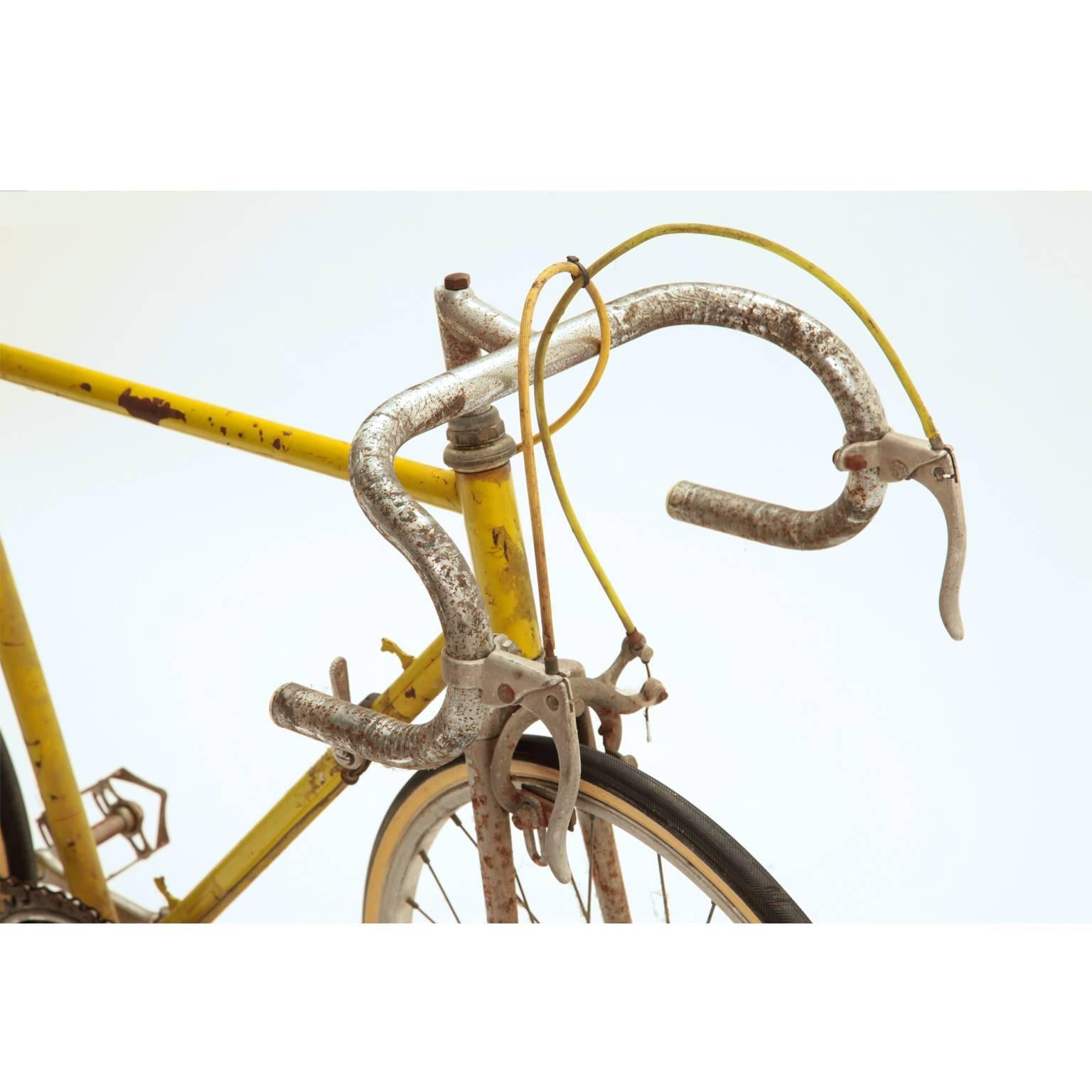 Unusual competition racing bike by Campagnola for children. With 20'' wheels, leather saddle and rims by Ambrosio. It is yellow lacquered and has chrome rims, pedals and handlebar.
