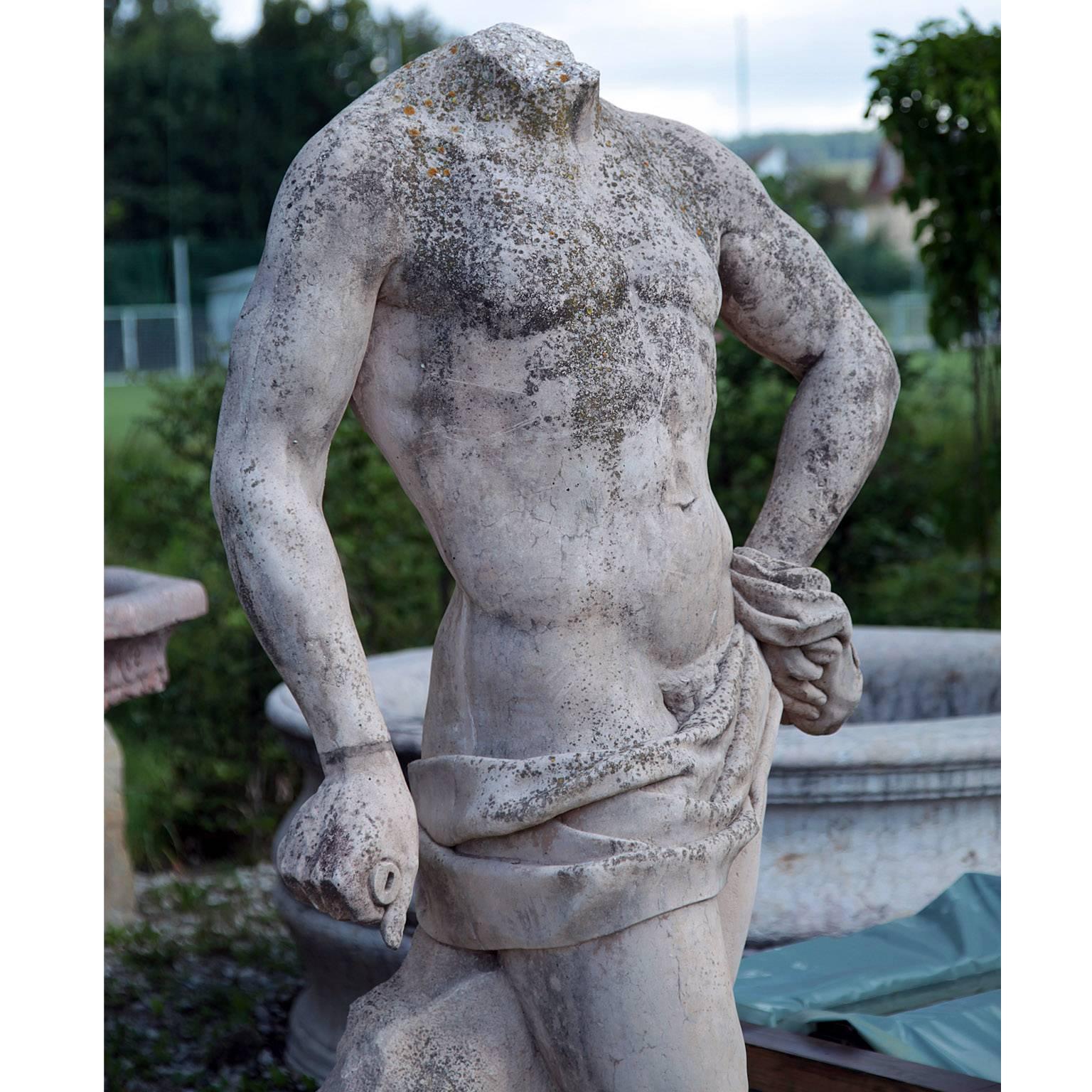 Stone sculpture of a male torso with loincloth after an antique model. Beautiful natural patina.