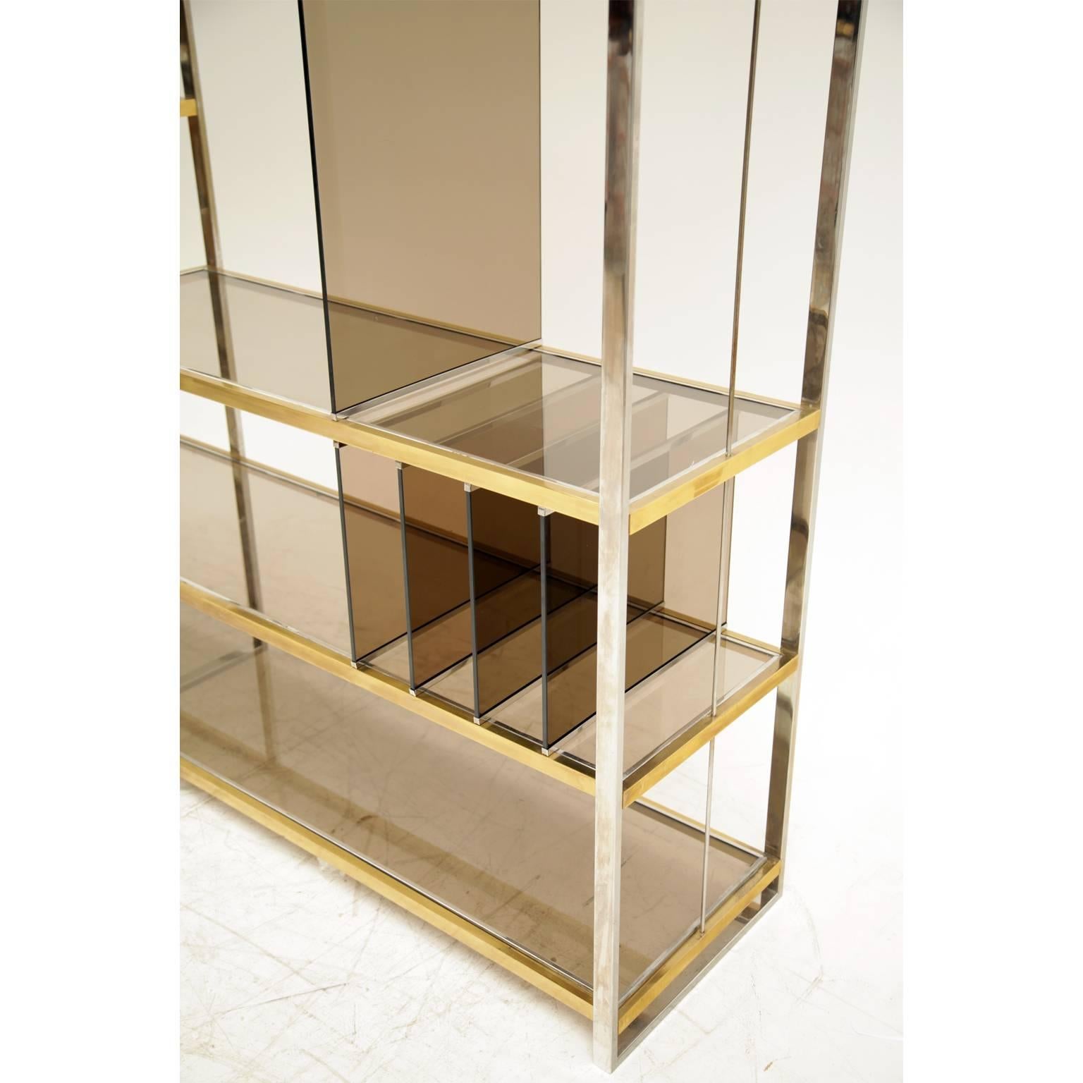 Very tall open shelving system by Romeo Rega out of chrome and brass with smoked glass shelves some spaced perfectly for vinyl records. Could also be used as a room divider.