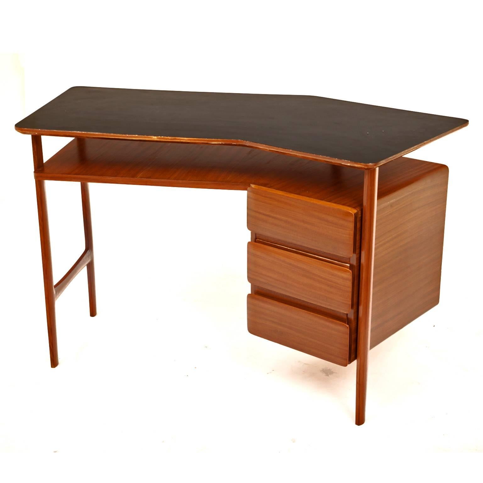 Writing desk with three drawers and a slightly curved tabletop.