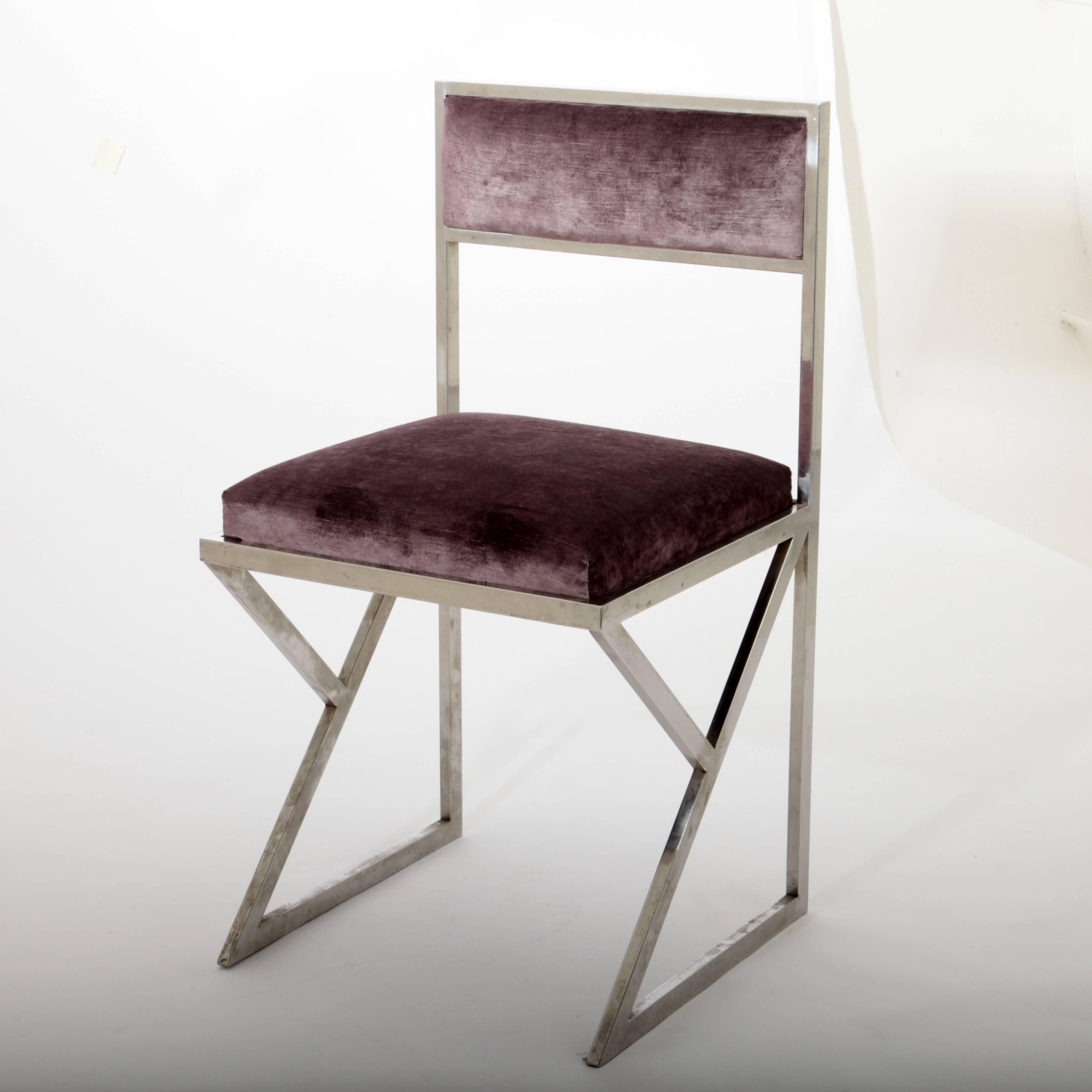 Pair of chairs with violet velvet upholstery and chromed legs.