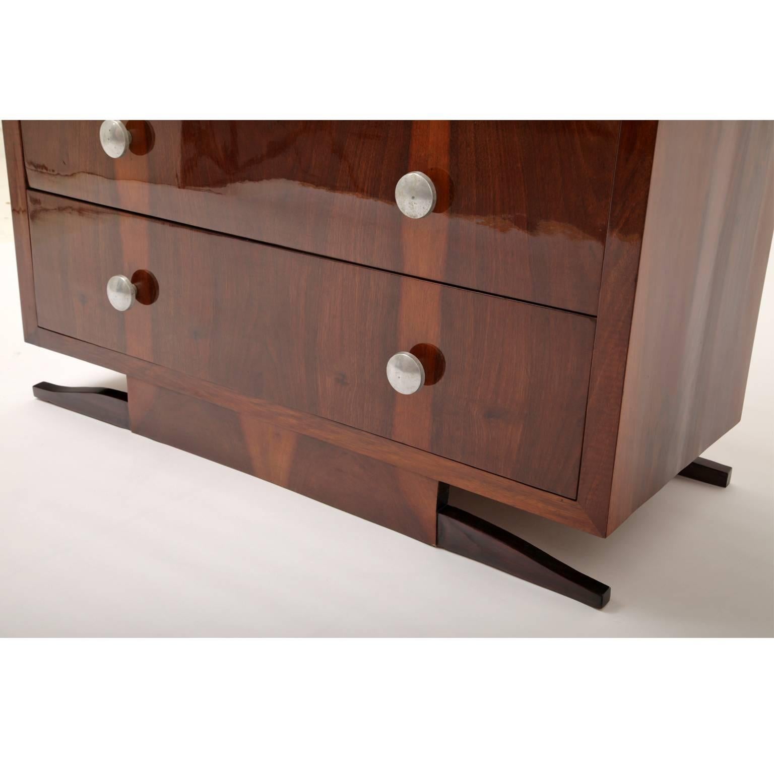 Art Deco chest of drawers with a straight body and round, silver handles.