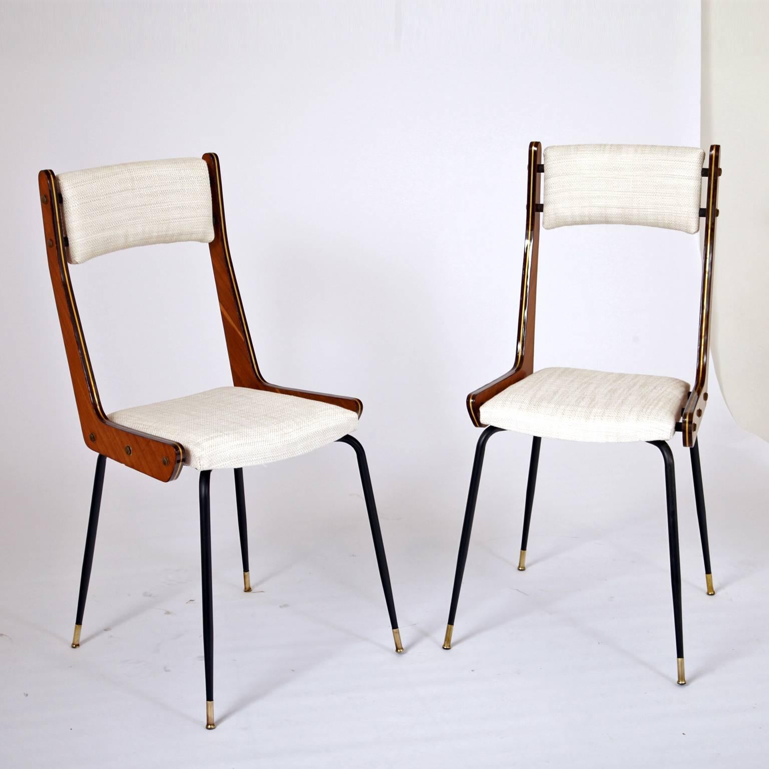 Pair of Italian chairs on iron legs with brass sabots. Backrest and seat upholsted in off-white.