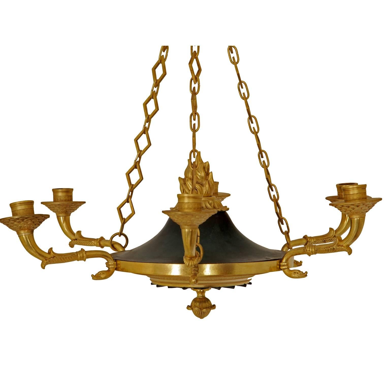 Six-arm bronze chandelier with palmettes and blossoms decor, flower crown and a torch flame ornament in its centre. The bronze is already carefully restored and cleaned.

For the electrification we assume no liability and no warranty.