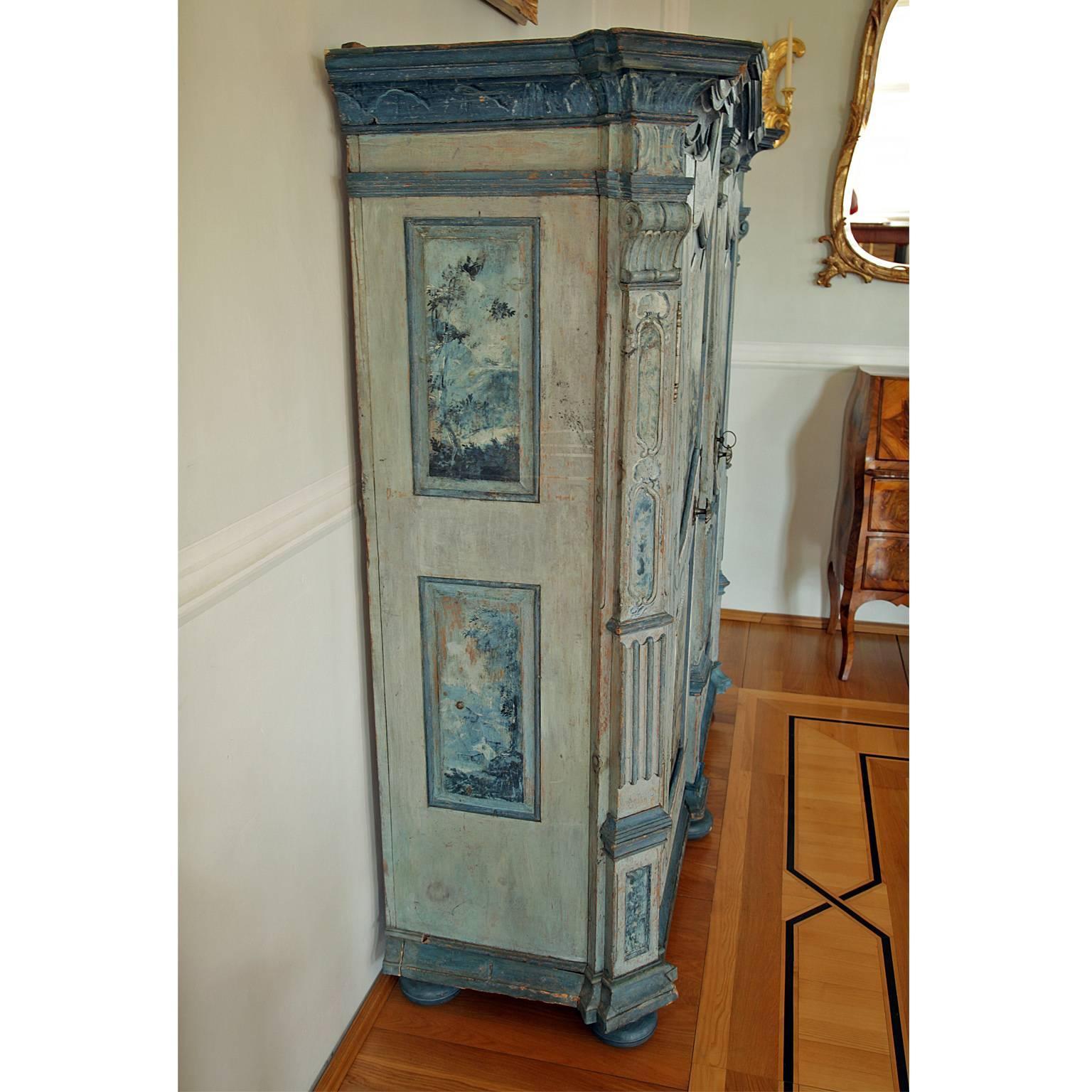Baroque Cabinet on ball feet with two doors and a serpentine cornice. The doors and side panels have two fillings each. These are all decorated with camaieu scenes attributed to Gaspare Diziani (1712-1769). The slanted corners and the central