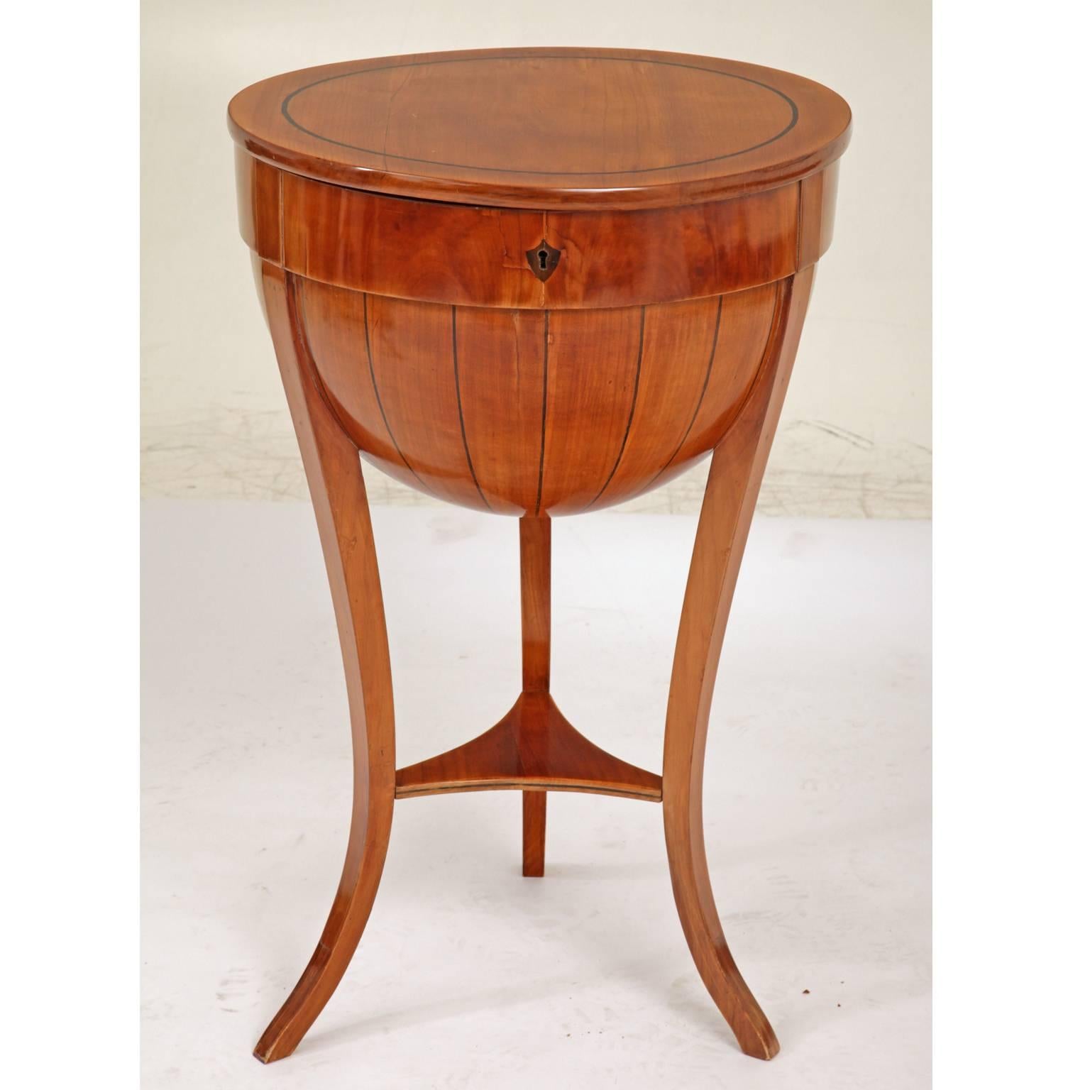 Tripod Biedermeier-style half-globe table with trefoil strutting and thread inlays. The interior has lots of compartments and nooks as well as a pincushion.