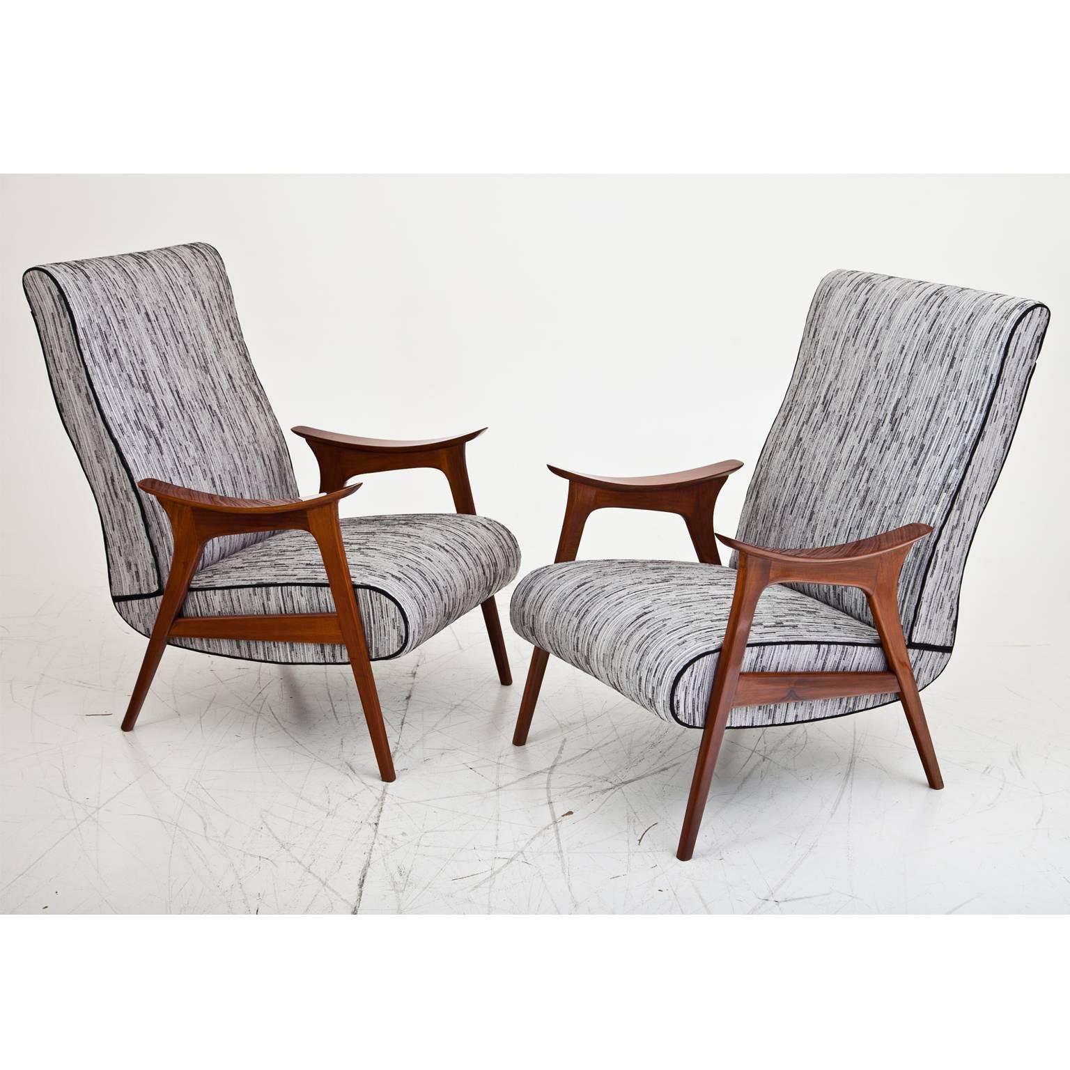 Pair of armchairs with very beautiful slightly curved armrests and large backrests. The chairs are completely restored and upholstered with a new, high quality fabric.