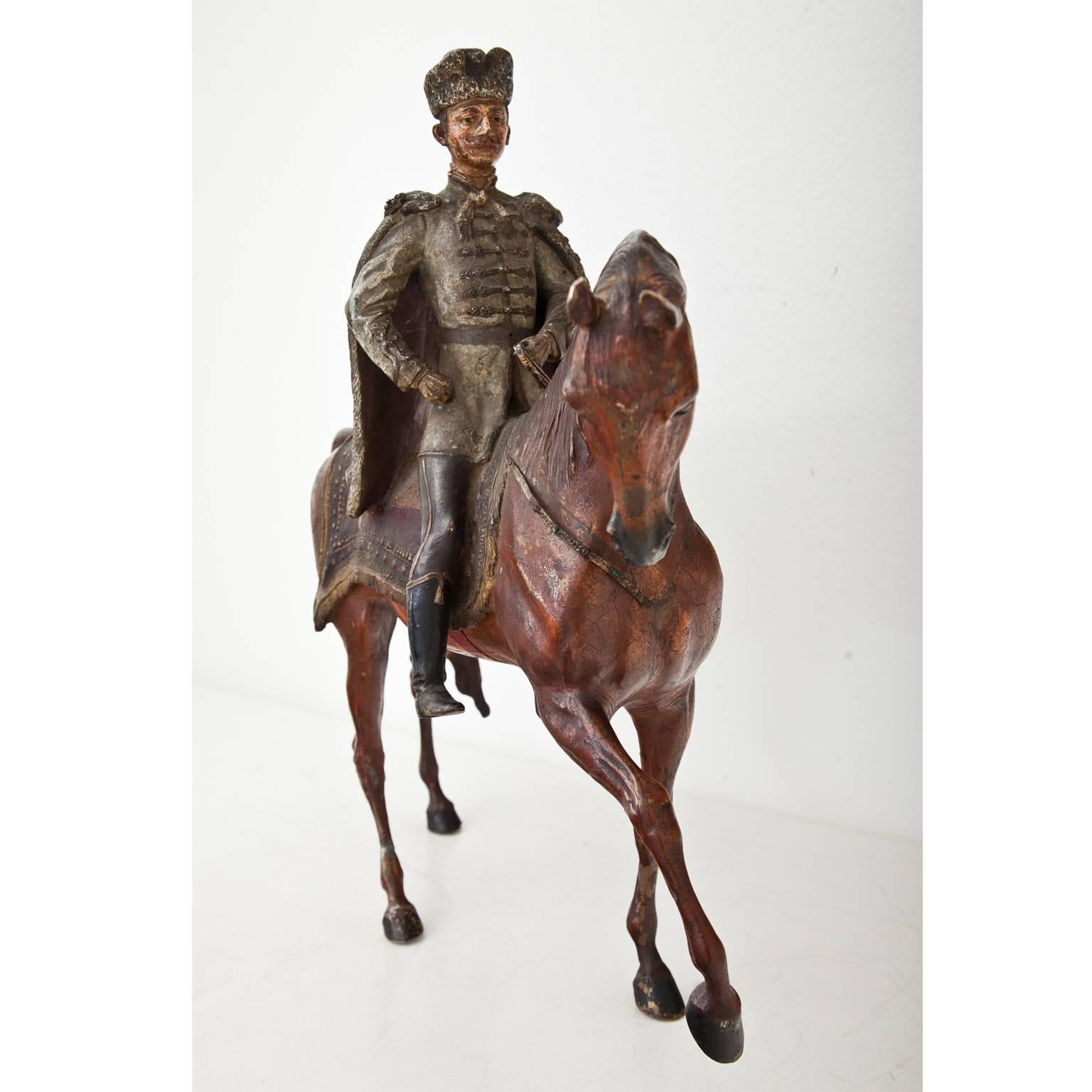 Viennese Bronze Hussar in an absolut unusal size on a striding horse. The bridle is decorated with small glass cabochons. The paint is original, the bronze has smaller repairs but is in an overall good condition.
On November 21, 1916 Emperor Franz