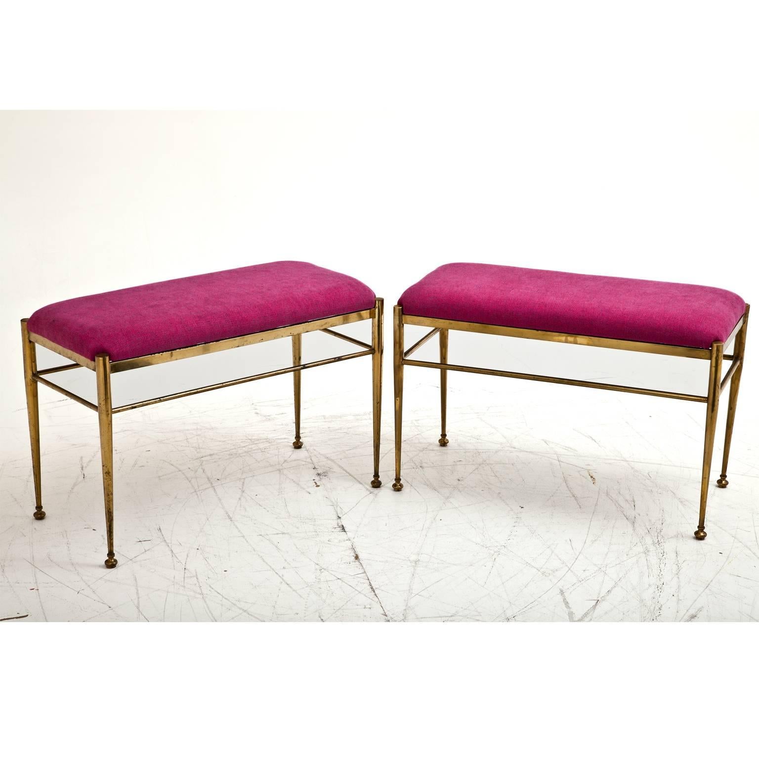 Pair of small benches on tapered brass feet. The benches are reupholstered with a high quality fabric.