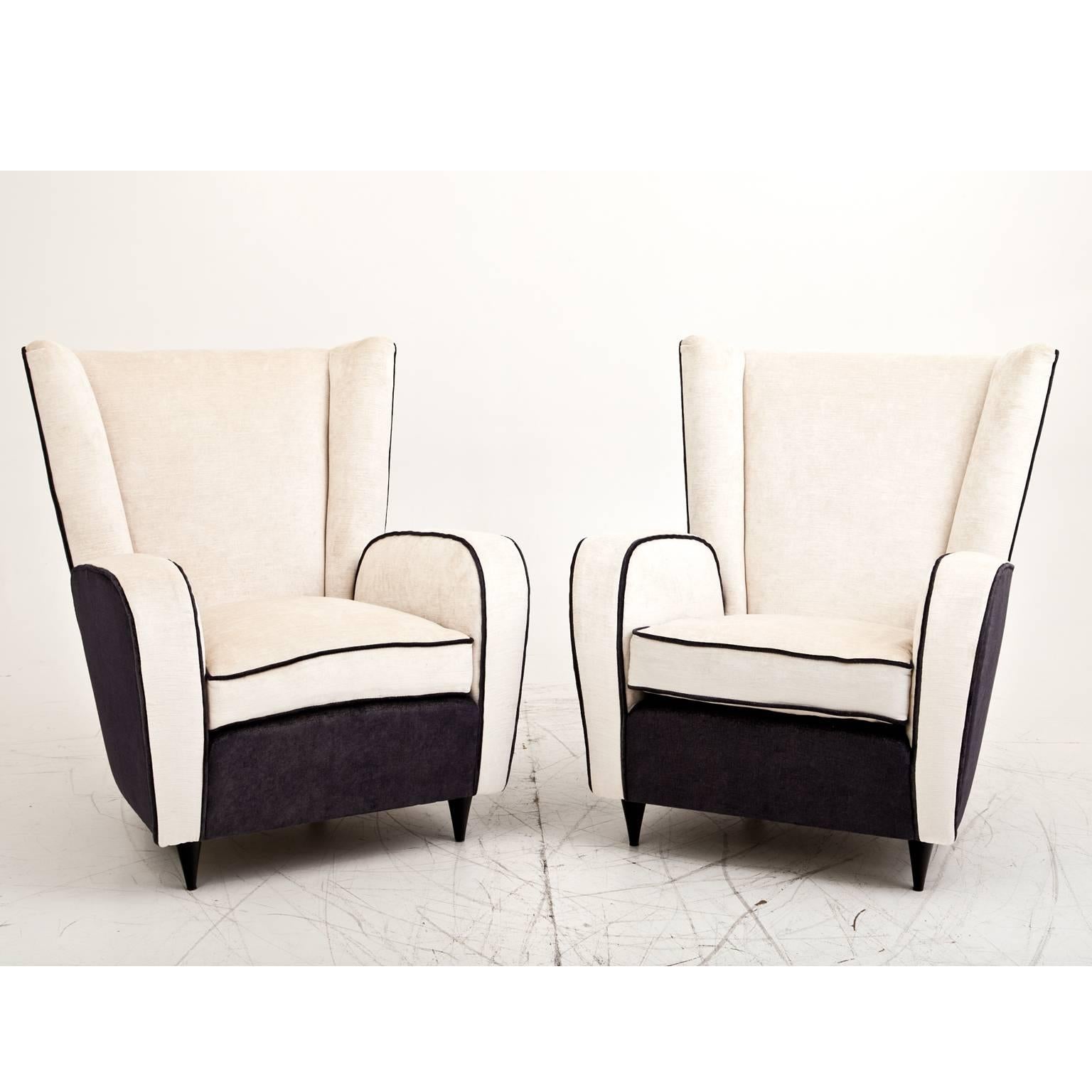 Pair of armchairs attributed to the Italian designer Paolo Buffa on black cone-shaped feet. The chairs are reupholstered with a high quality fabric. The front is mostly in beige, the sides and back are in a beautiful blue-anthracite color.