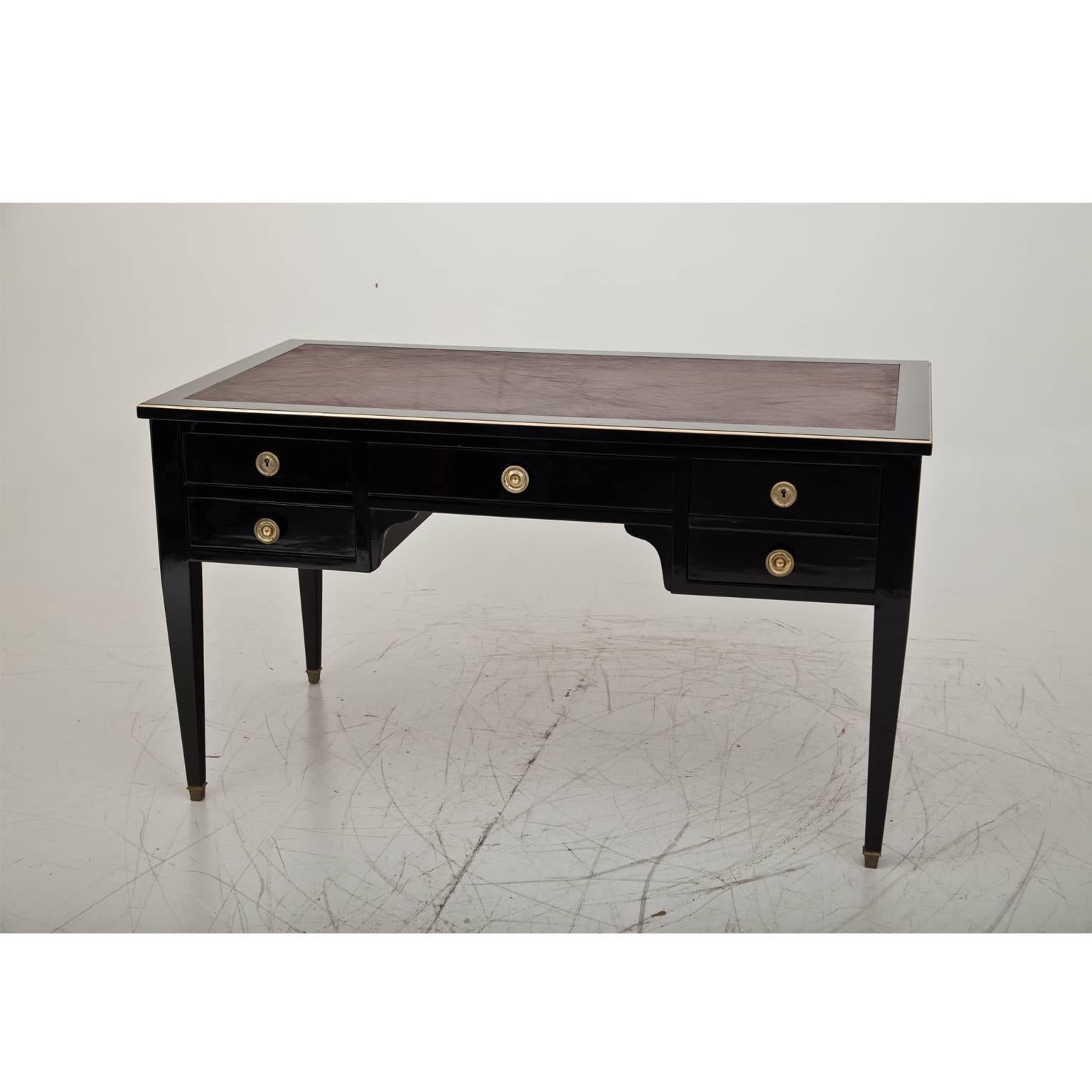 Five-drawered, newly ebonized Empire-style desk from 1880 on tapered legs with brass sabots and brown vinyl-leather surface.
  