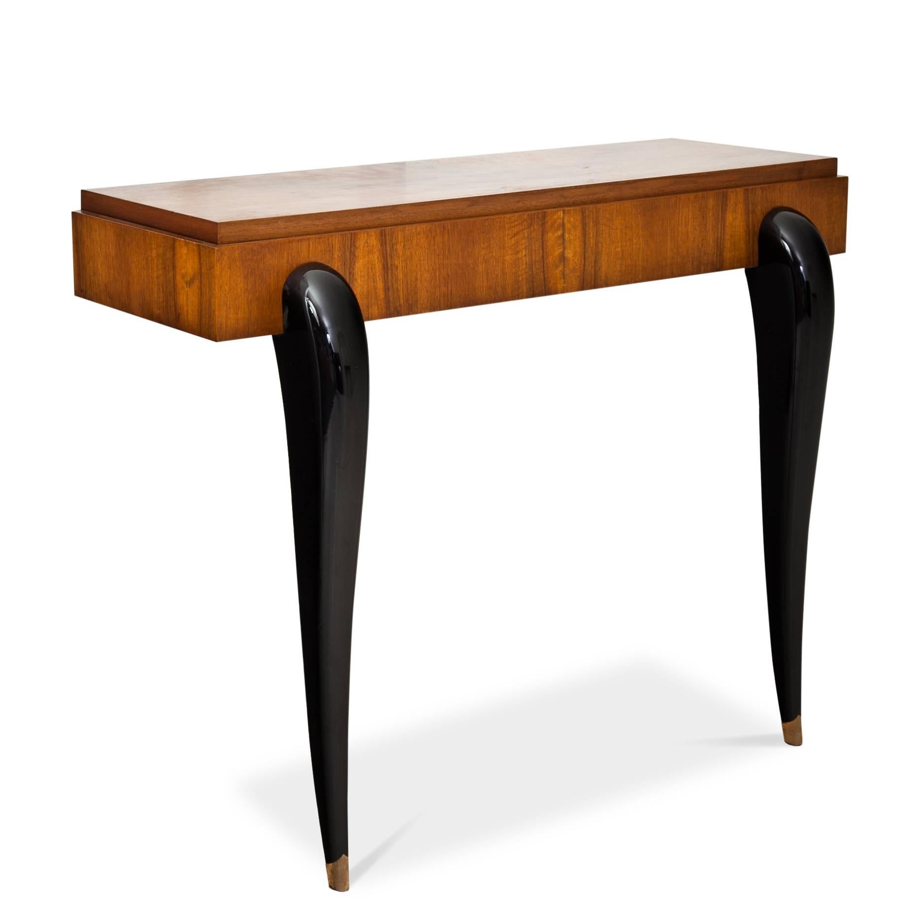Pair of Art Deco-style console tables with elegant curved, ebonized legs and rectangular tops. The consoles were redesigned under use of old parts.