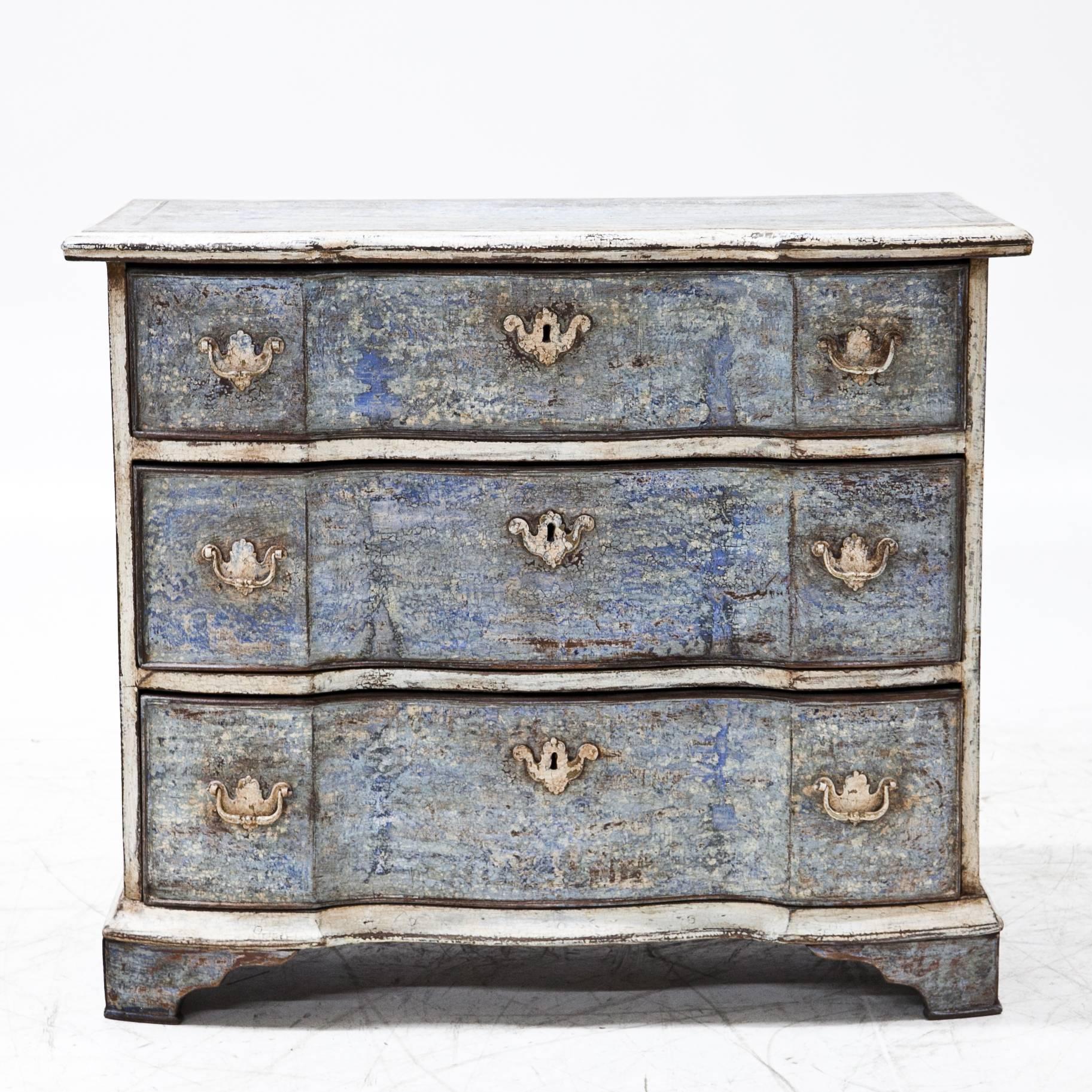 Three-drawered Baroque chest of drawers with a serpentine front. The paint was redone after traditional designs. The worn look gives it a wonderful decorative character.