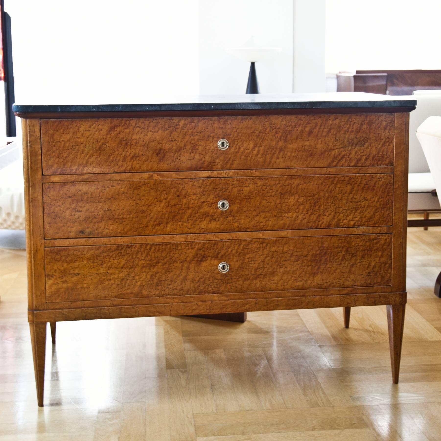 Italian three-drawered chest on tapered legs, with a very beautiful bird's-eye maple veneer. The marmor top was added later.