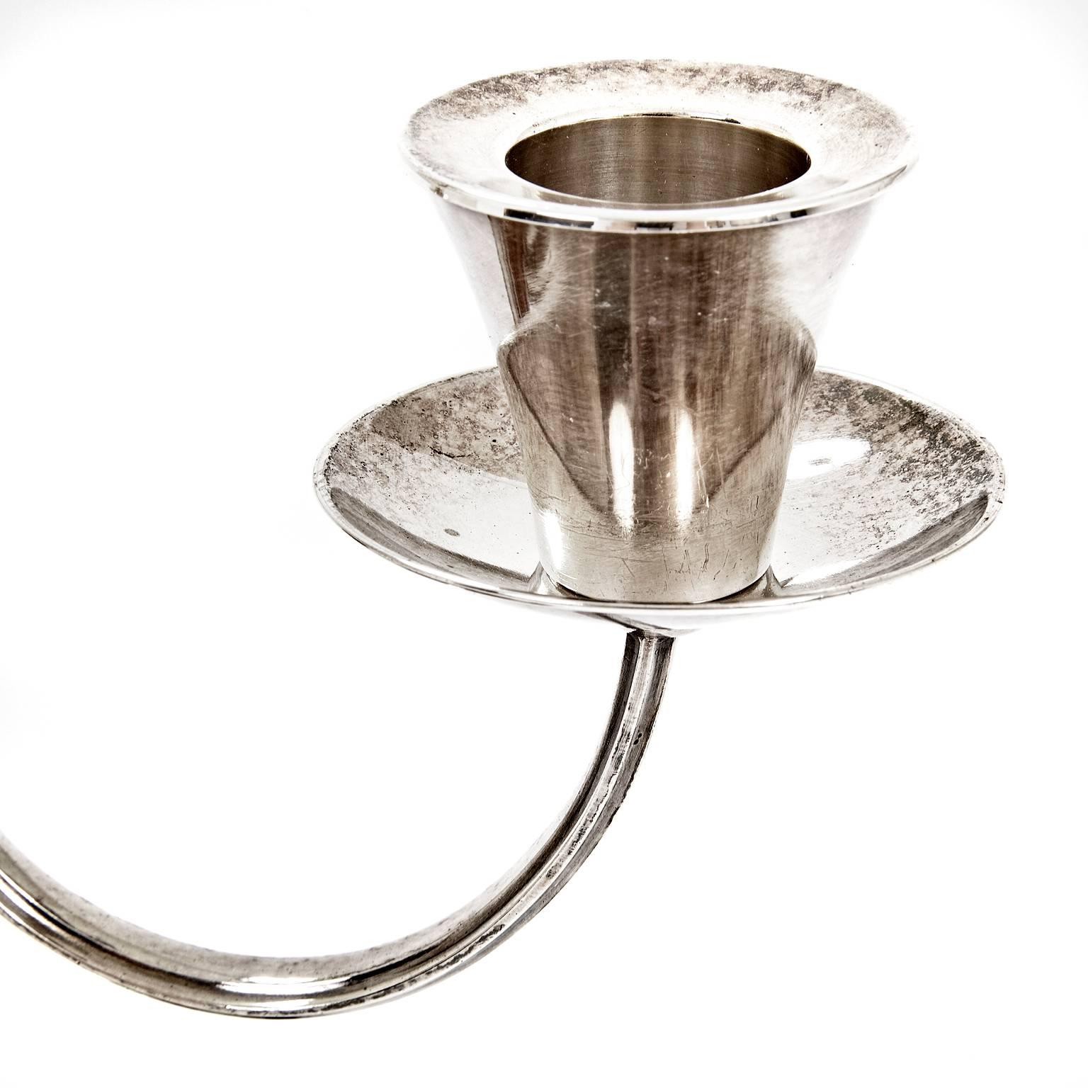 A stunning Art Deco candleholder on a round base with a fluted shaft made of wood and two arms made of silver. A marking on the foot reads 