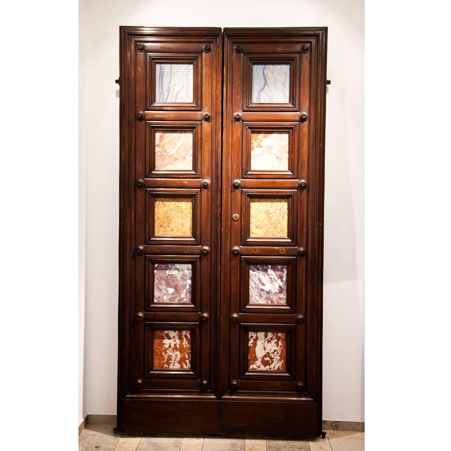 Unusual double-door out of solid carved wood with marble fillings in different colors.