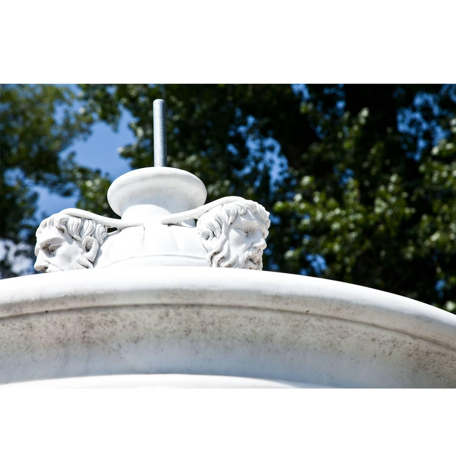 Large courtly fountain out of hand-cut and hand-carved marble in a neoclassical style. The three graces surround the central column, above is another basin with waterspouts in the shape of lion and male head's.
The wall of the large basin is H: 36