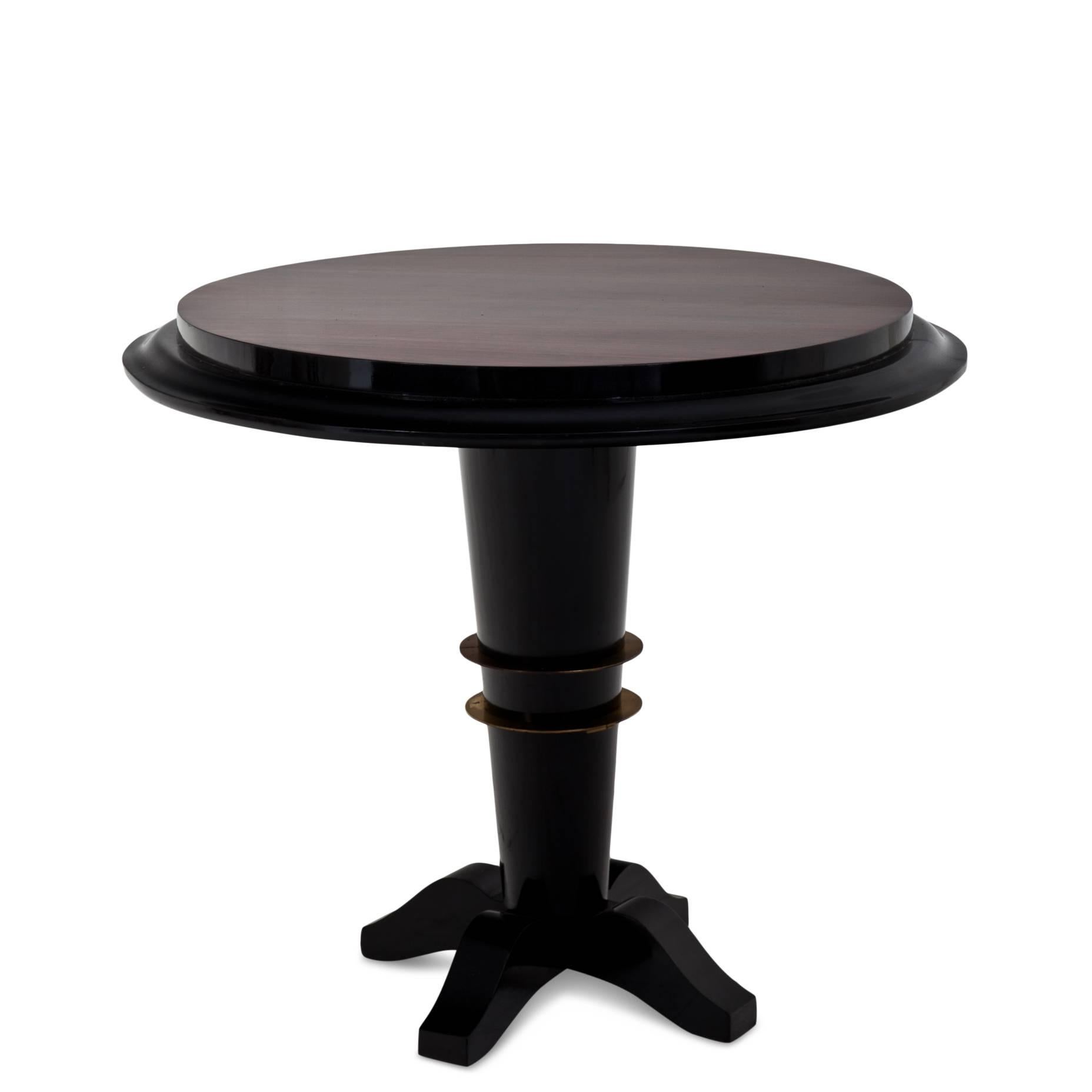 Ebonized Art Deco side table on a conical stand with four feet and a double brass ring around the middle. The tabletop shows a very beautiful mirrored veneer pattern.