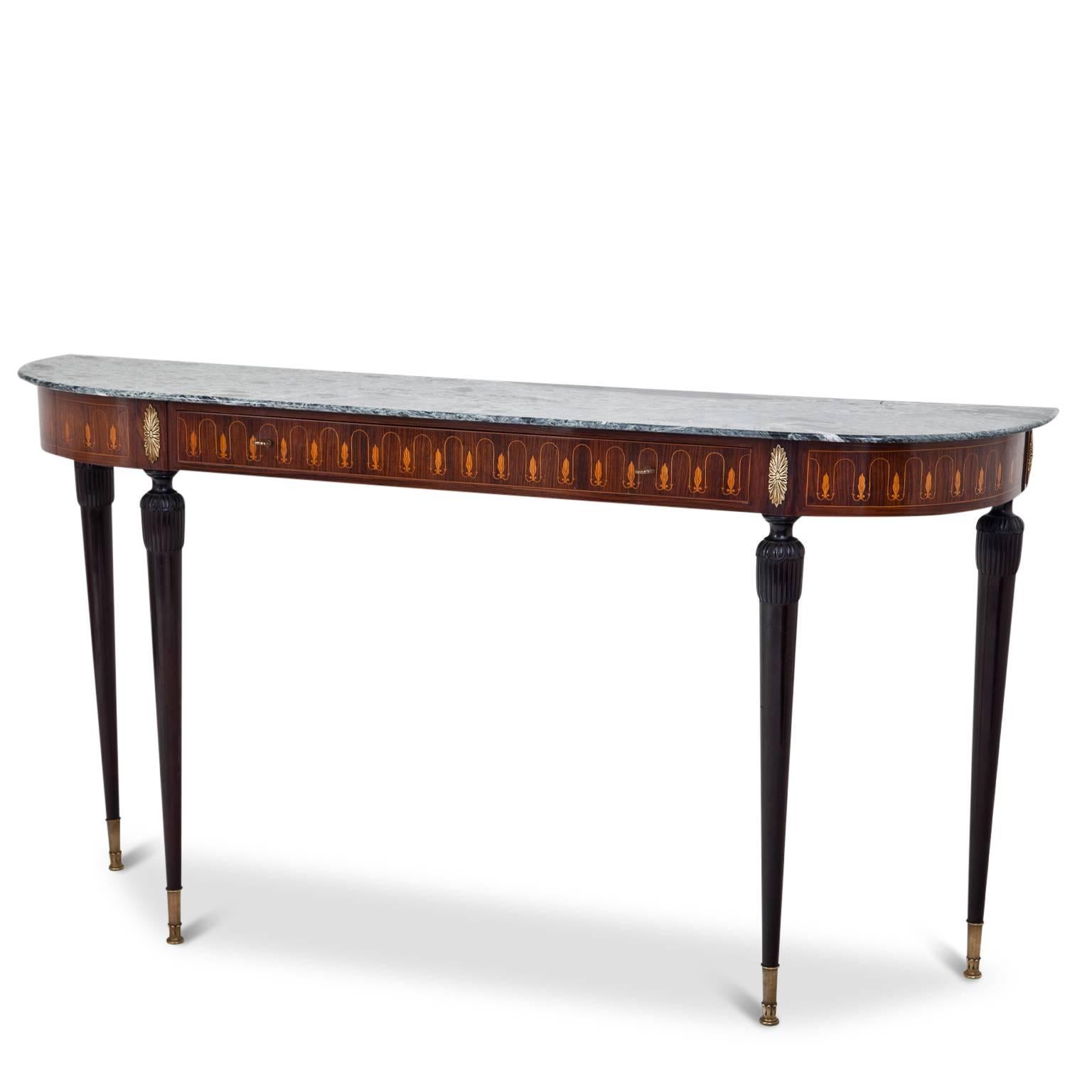Console table in the style of Paolo Buffa, manufactured by Palazzi dell'Arte Cantù. The console table stands on long tapered legs with brass sabots. The rim is decorated with ornamental inlays and the console has a very beautiful grey-blue marble