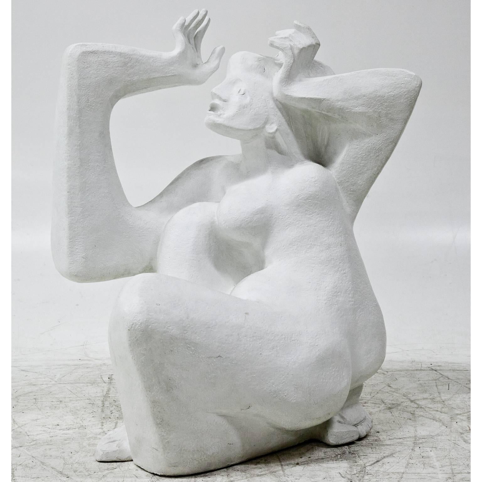 Expressionistic plaster figure of a crouching female with wide-open eyes and an open mouth, the arms are geometrically shaped and rise to her head in an ecstatic state. The white, rough surface shows some signs of wear. The sculpture is not signed