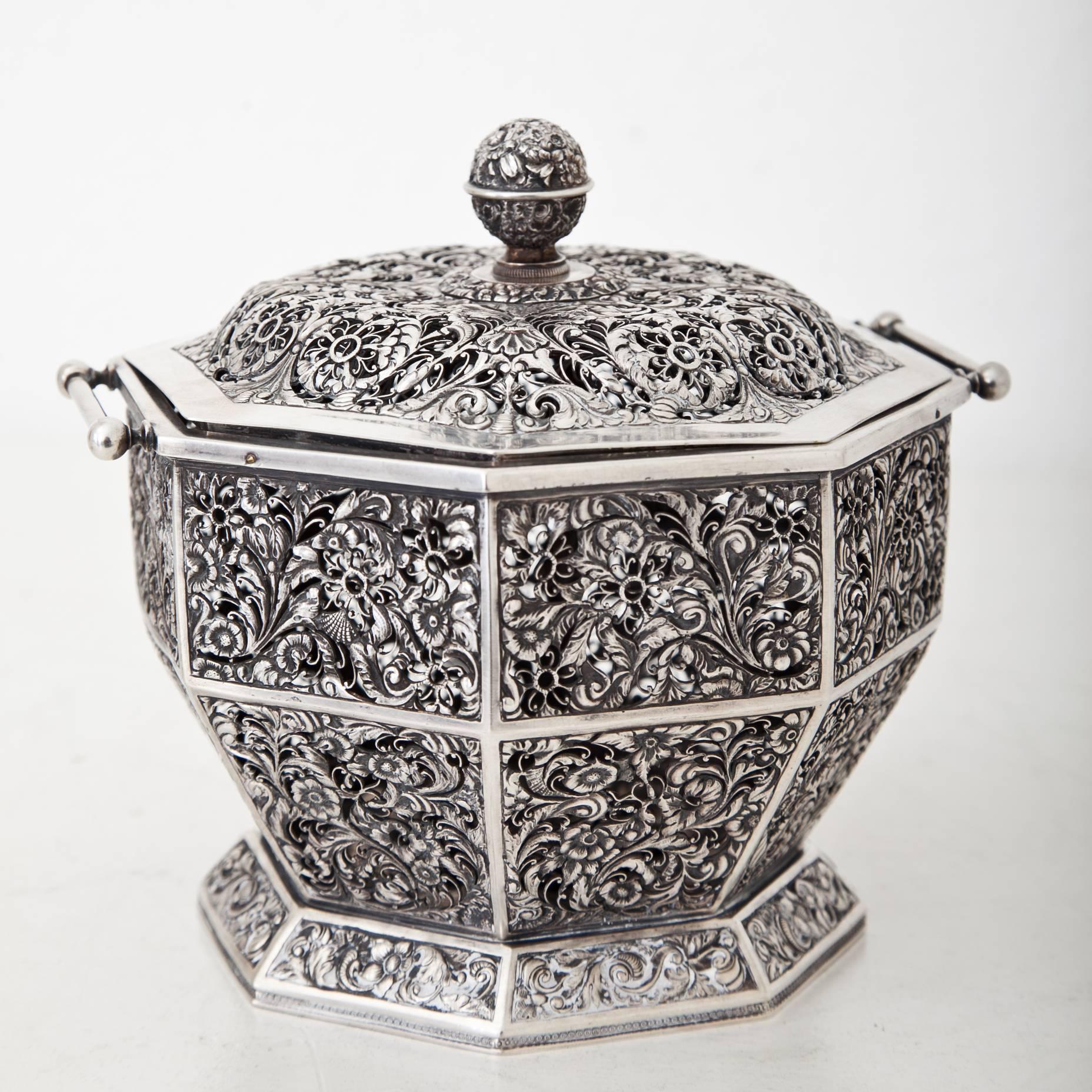 Octagonal scent pot with open worked wall and lid and floral ornaments. The pot is embossed at the bottom with city mark for Vienna and maker's mark IK.