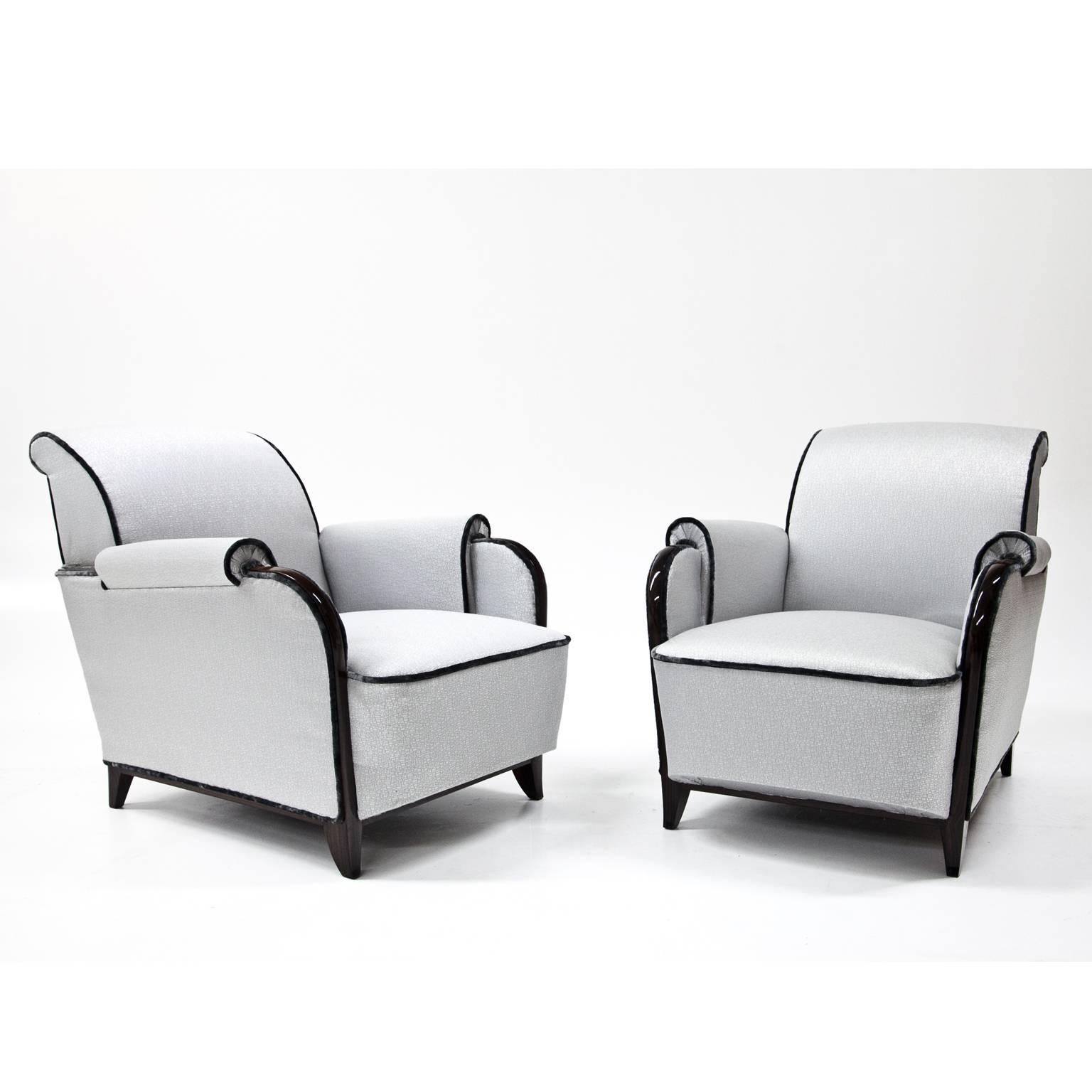 Pair of grey Art Deco lounge chairs on short tapered legs. The chairs are reupholstered with a high quality grey fabric and accentuated with black piping.