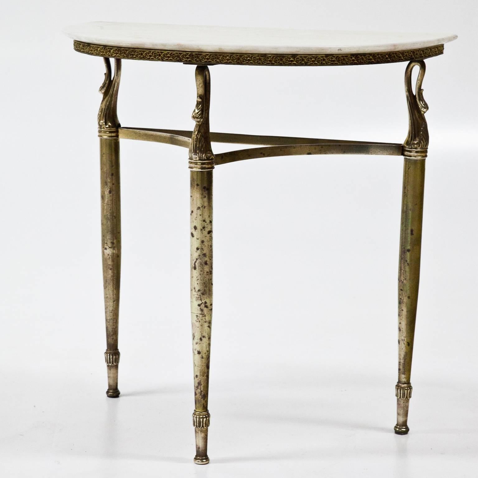 Pair of Italian bedside tables on a brass base with three legs and a marble top. One top has a chip.