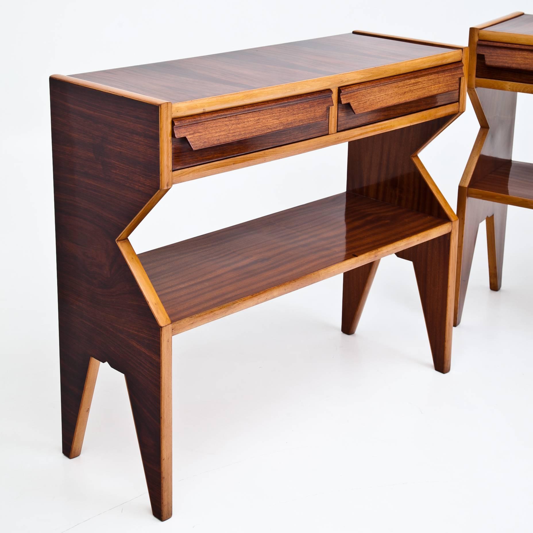 Pair of Italian console tables with an unusual profile, two drawers and one shelf. The consoles were professionally refurbished and polished.