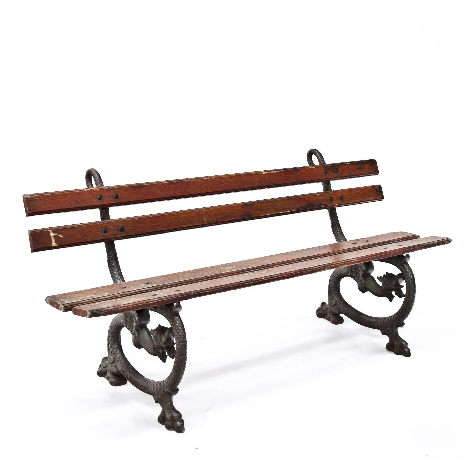 Elegant park bench on cast iron feet in the shape of dragons, stamped 