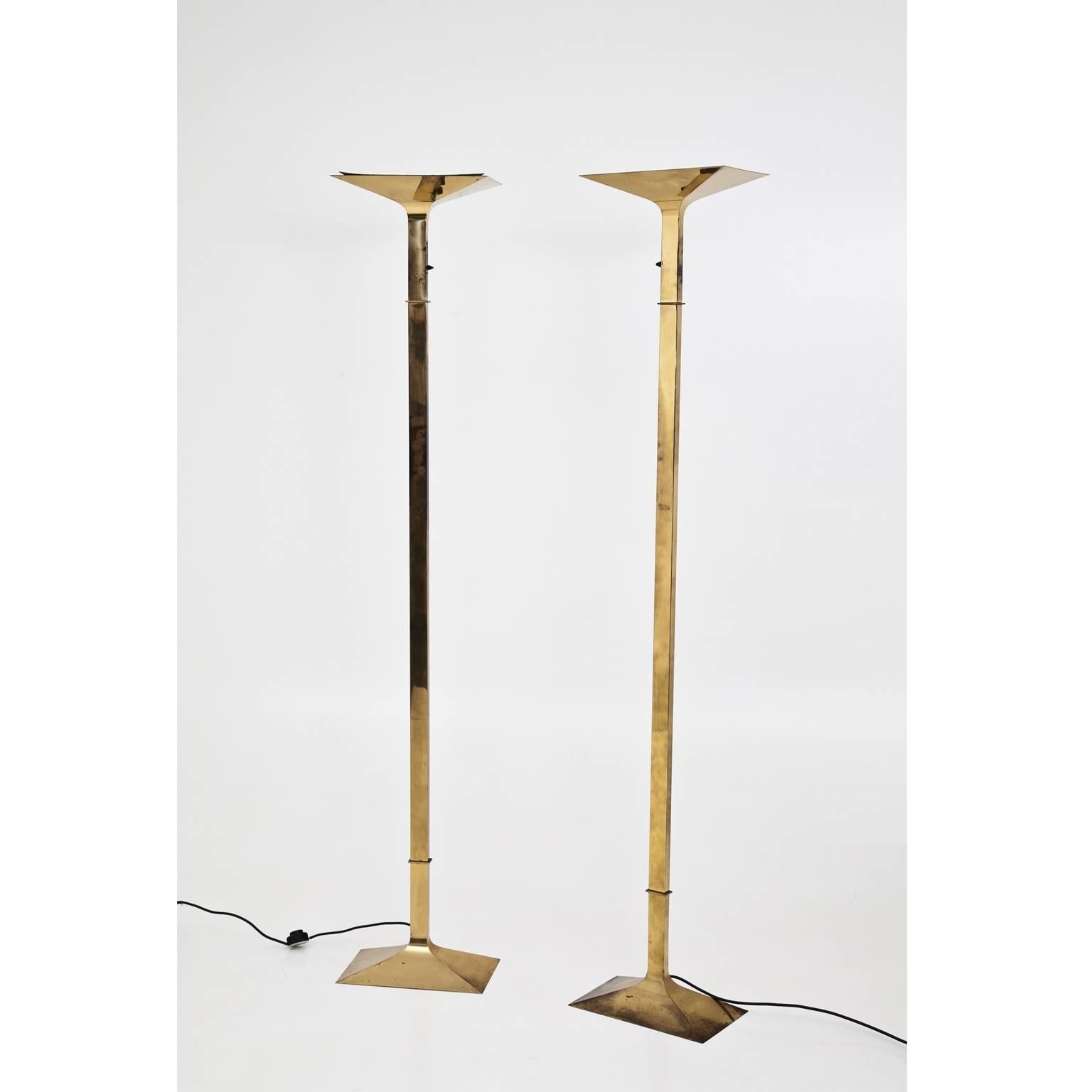 Pair of tall Italian floor lamps out brass with a rectangular Stand and smooth shaft. The brass is slightly tarnished.