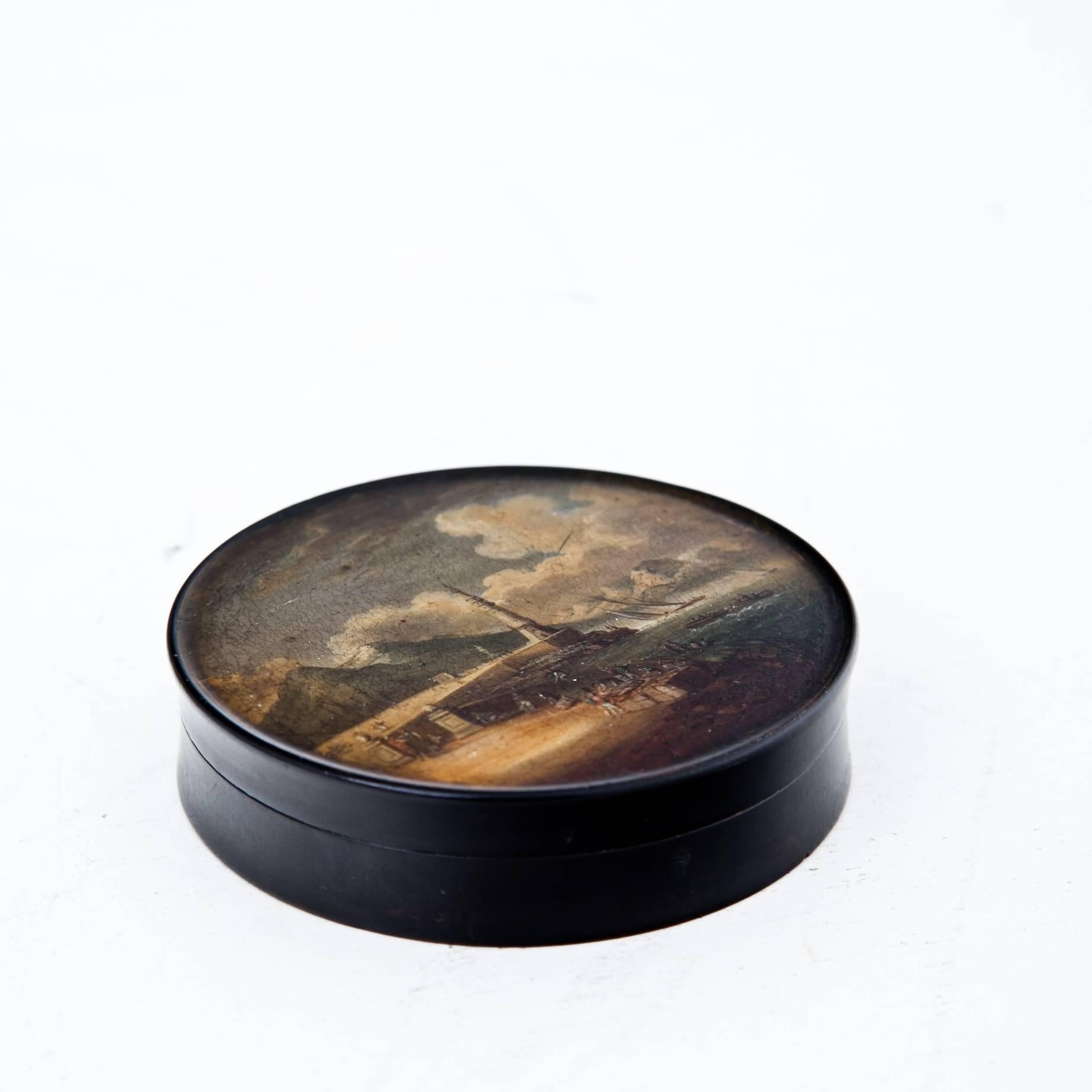 Round lacquer box with depiction of the Molo or light tower of Naples after Chatelet. The paint shows some craquelure.