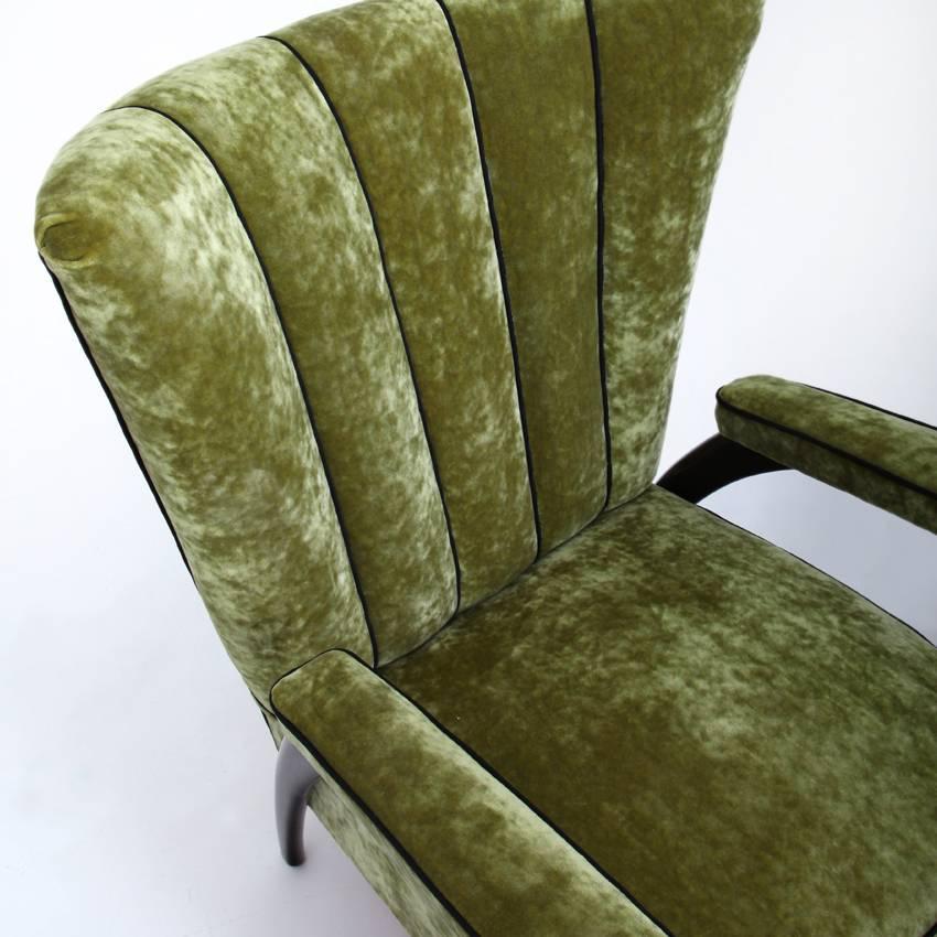 Pair of lounge chairs in the style of Paolo Buffa on conical wooden legs. The large trapezoidal scalloped backrest, the seat and armrests were reupholstered with a high-quality green fabric with black piping.