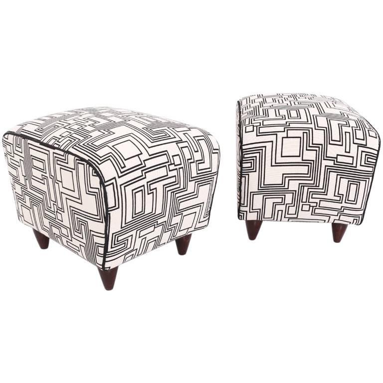 Pair of stools on short conical wooden legs with a trapezoidal seat. The stools were reupholstered with a high-quality, black and white fabric by designer Eley Kishimoto.