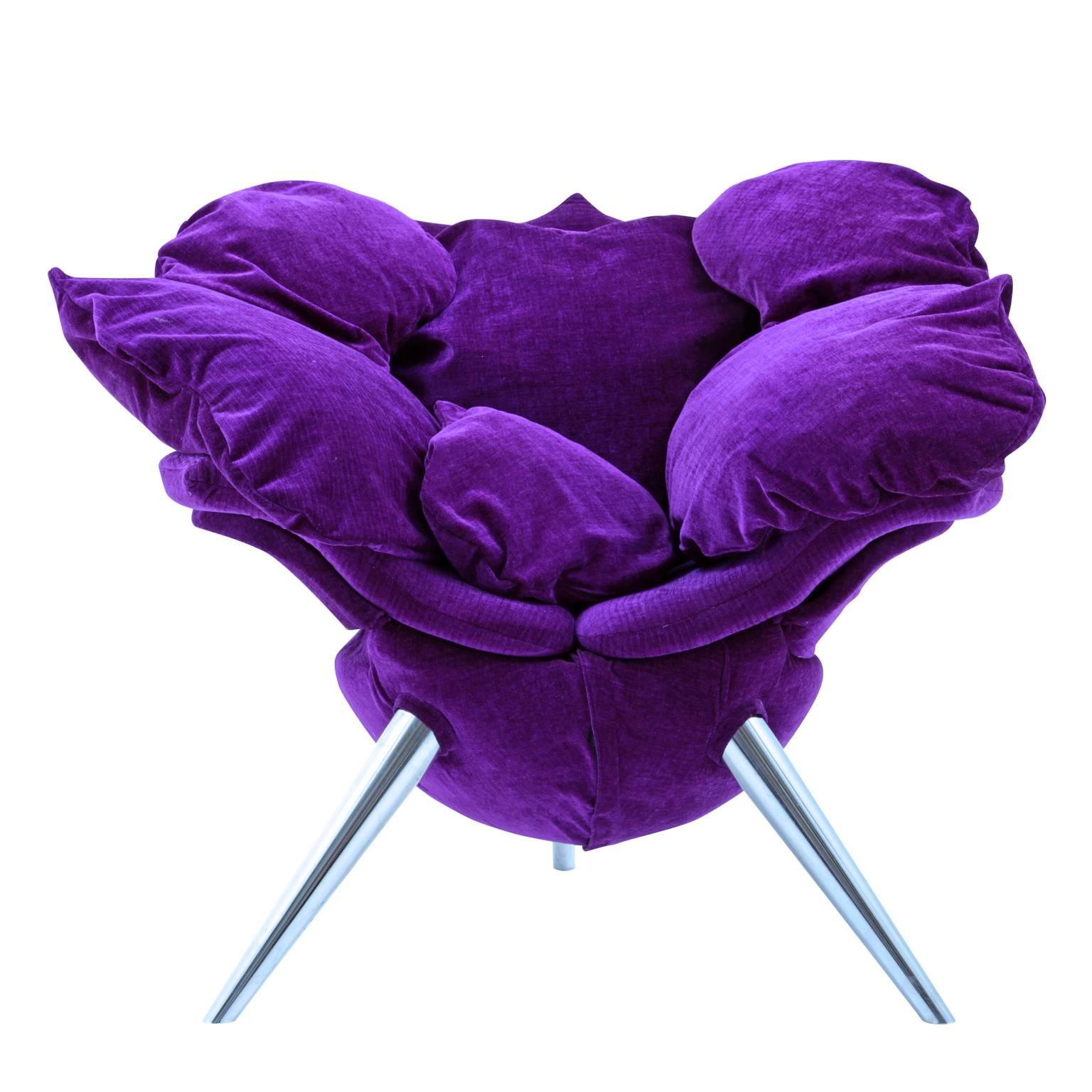 The chair stands on three conical tapered aluminium legs covered in a purple-colored suede fabric. The seat is decorated with voluminous rose pedal-shaped cushions, so the whole chair looks like a rose blossom. 
The Japanese designer Masanori Umeda