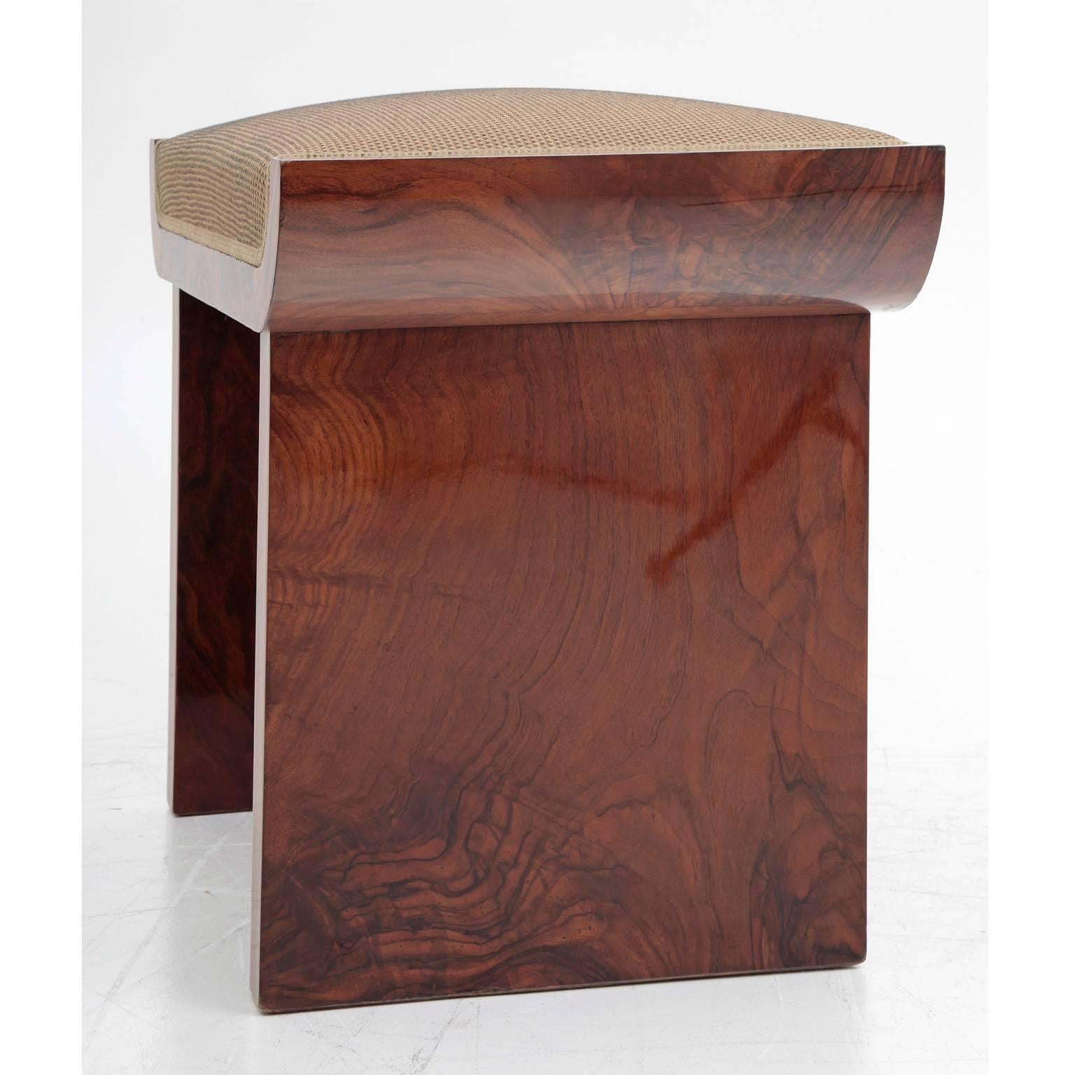 Art Deco Stool with new upholstery and a c-shaped seat that rest upon straight wooden panels. 
